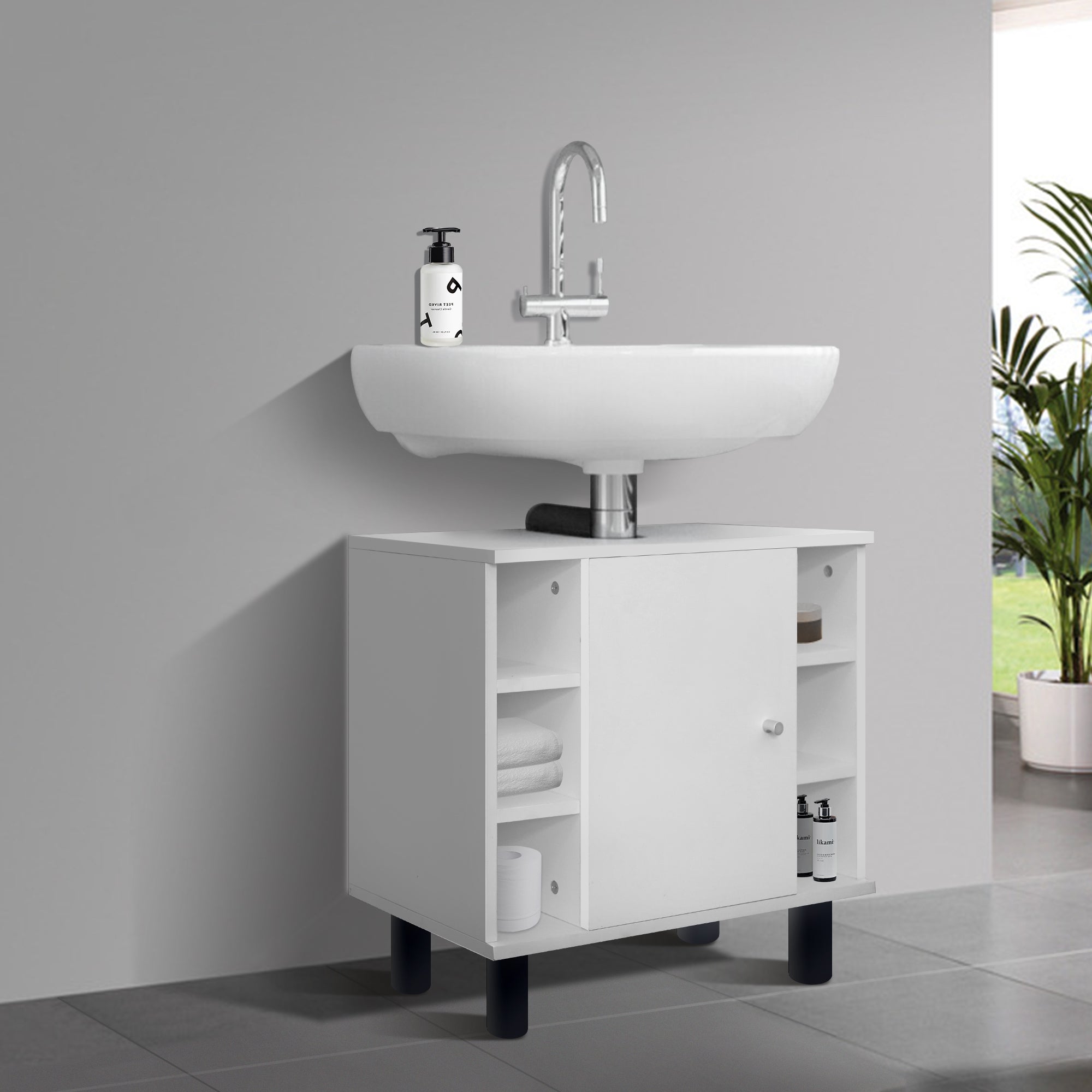 Weißer Unterschrank mit Waschbecken und Pflanzen im Hintergrund.