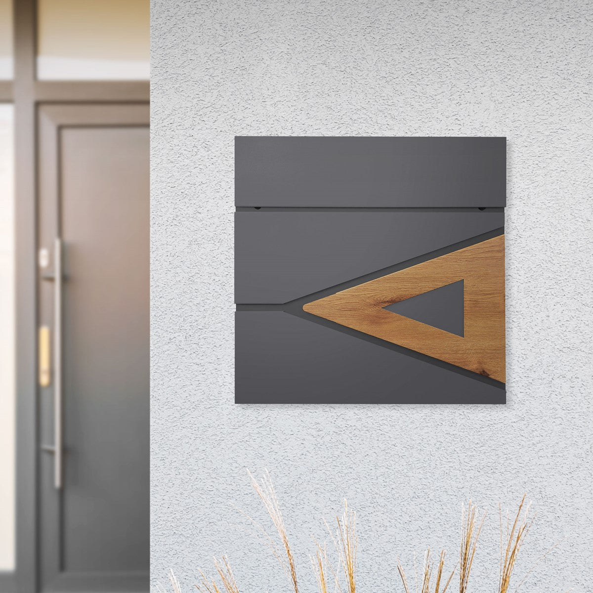 Grey wall with a modern letterbox made of wood and metal.