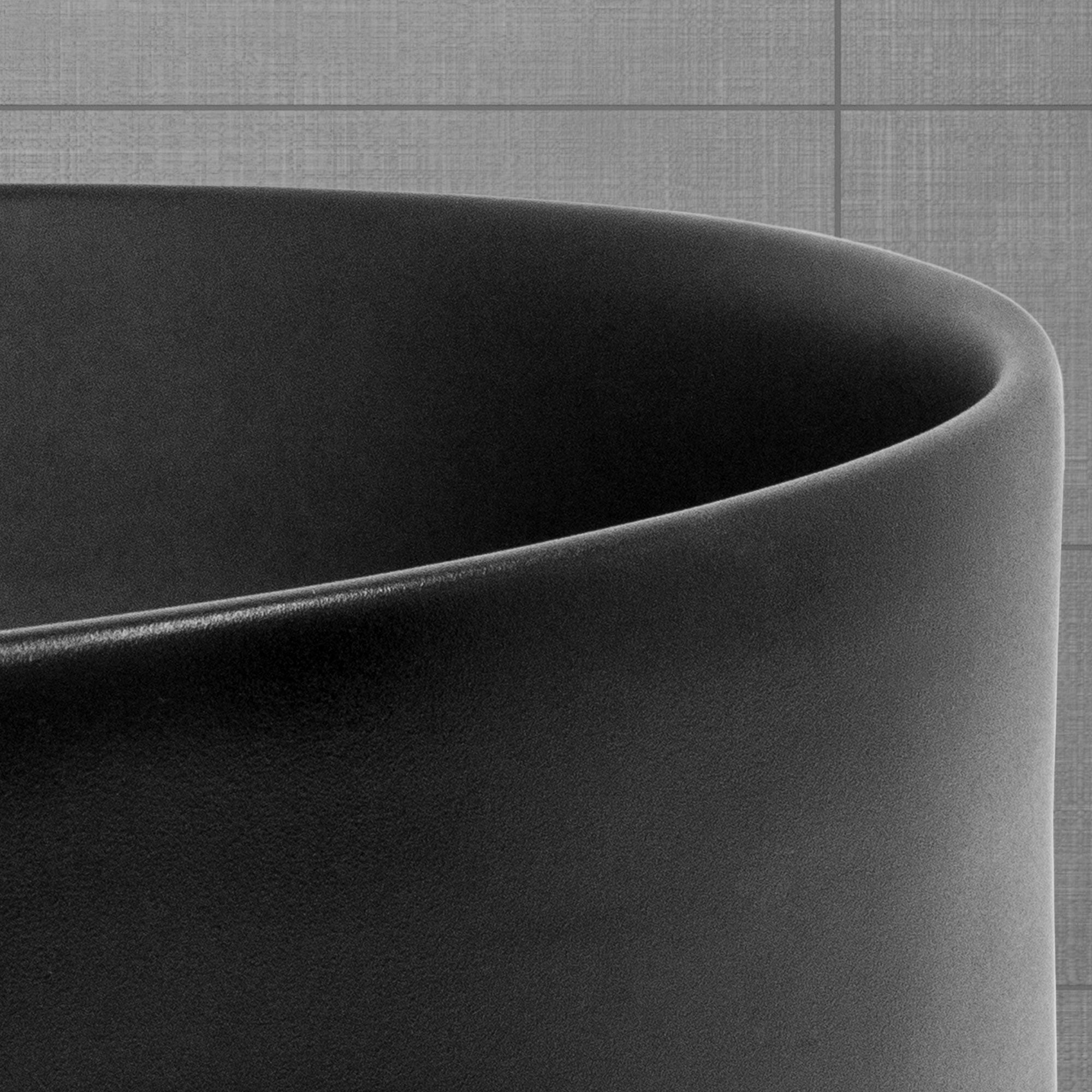 Close-up of a black, round container with a smooth surface.