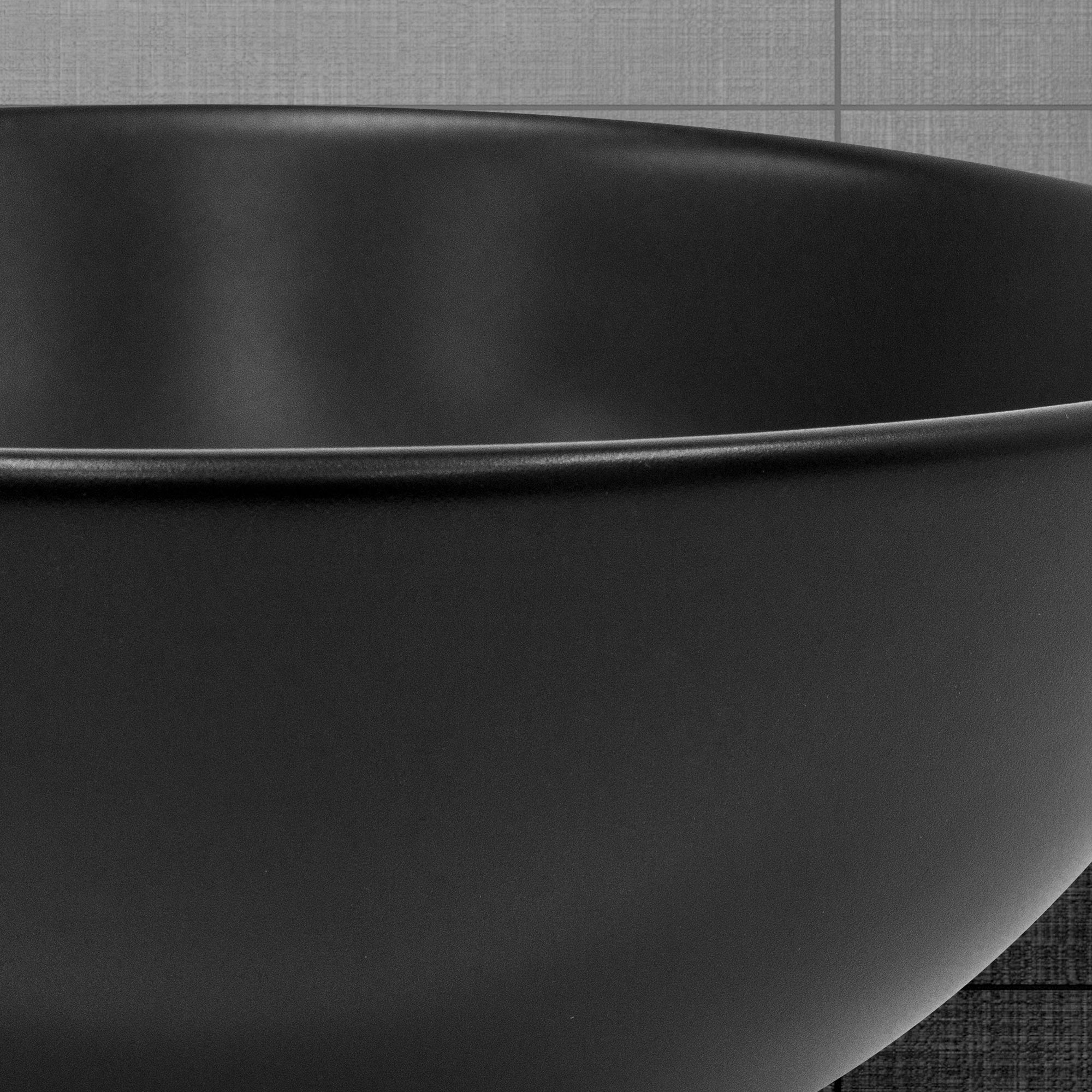 Black round bowl on a gray surface.