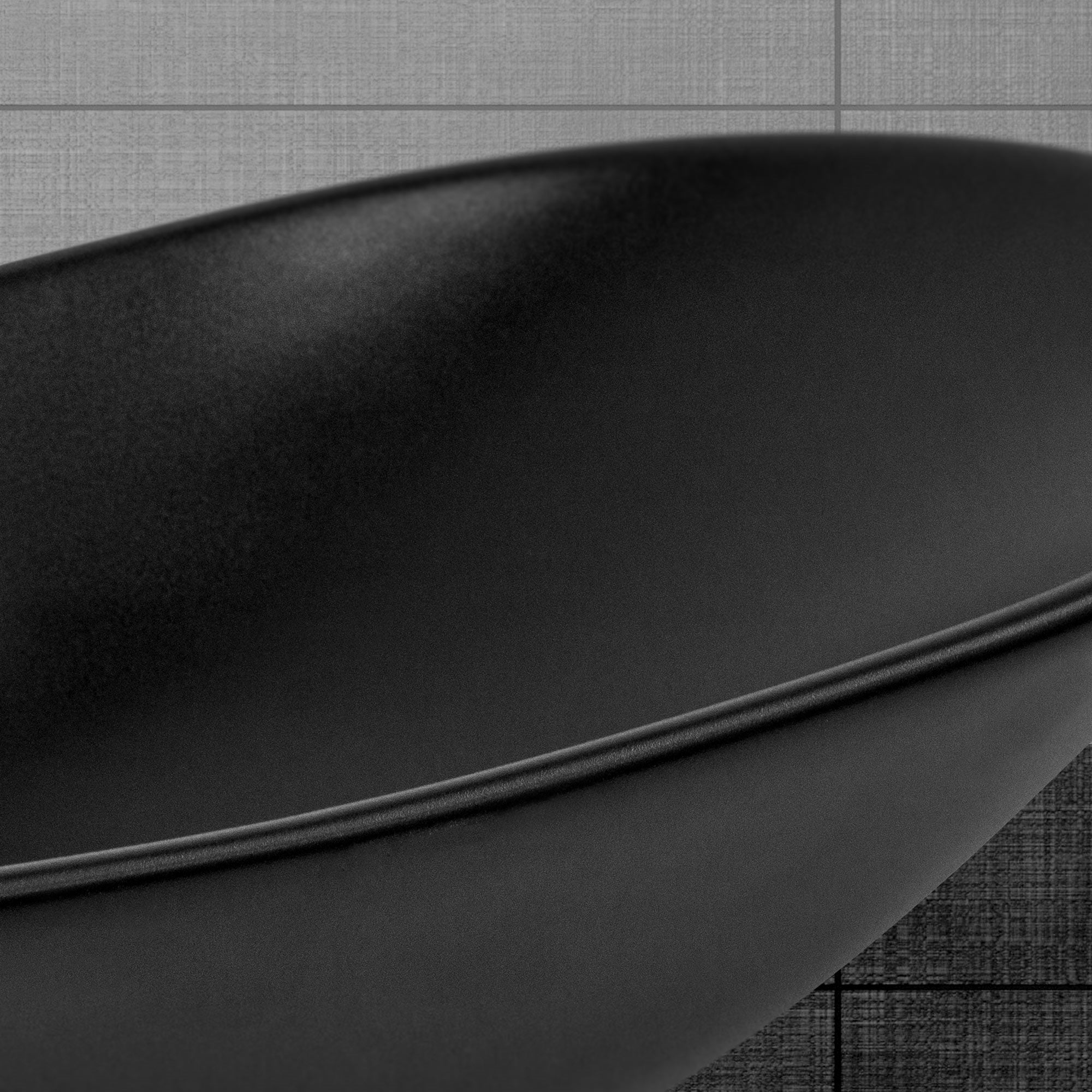 Close-up of a black sink with a smooth surface.