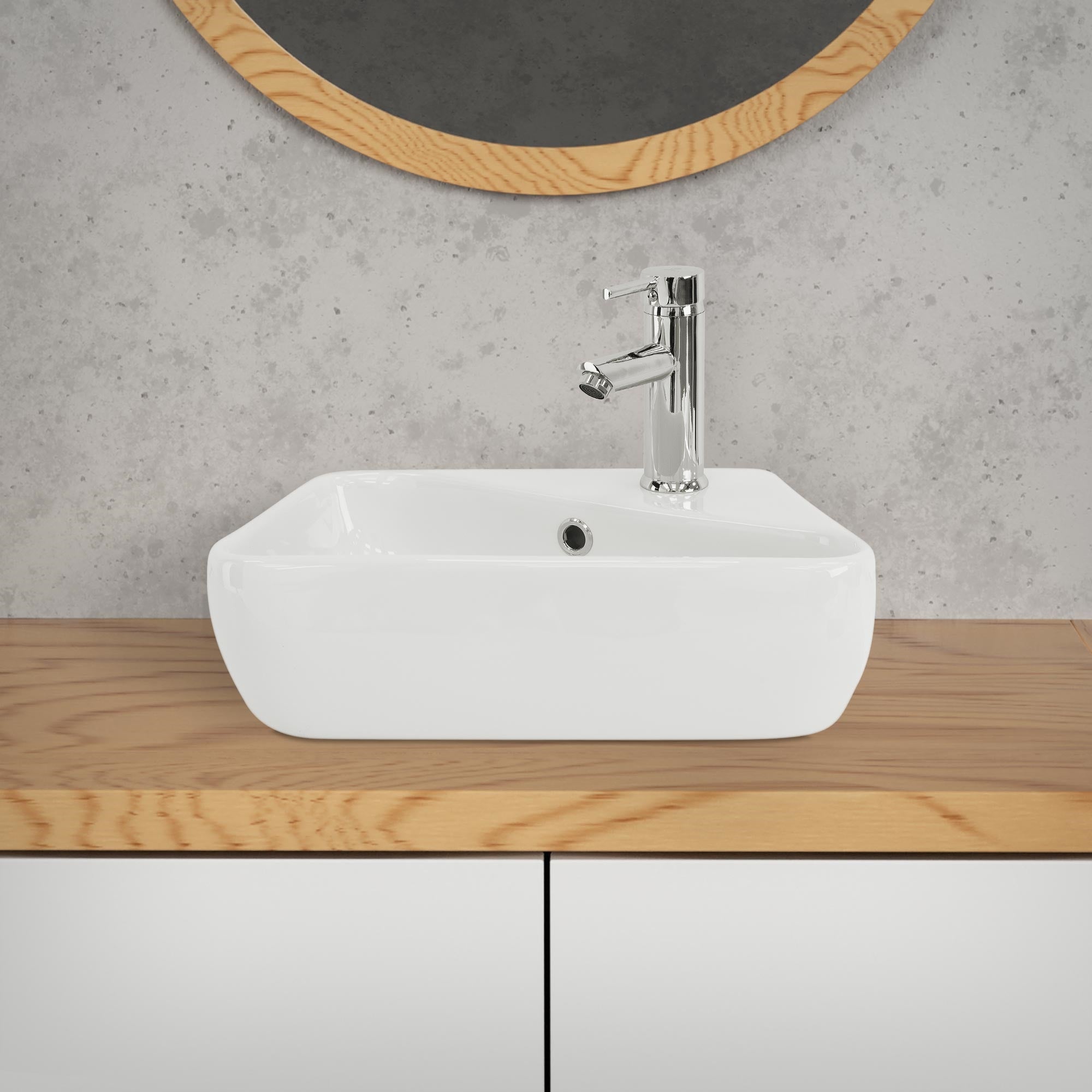Weißes Waschbecken auf einem Holzregal mit Wasserhahn.