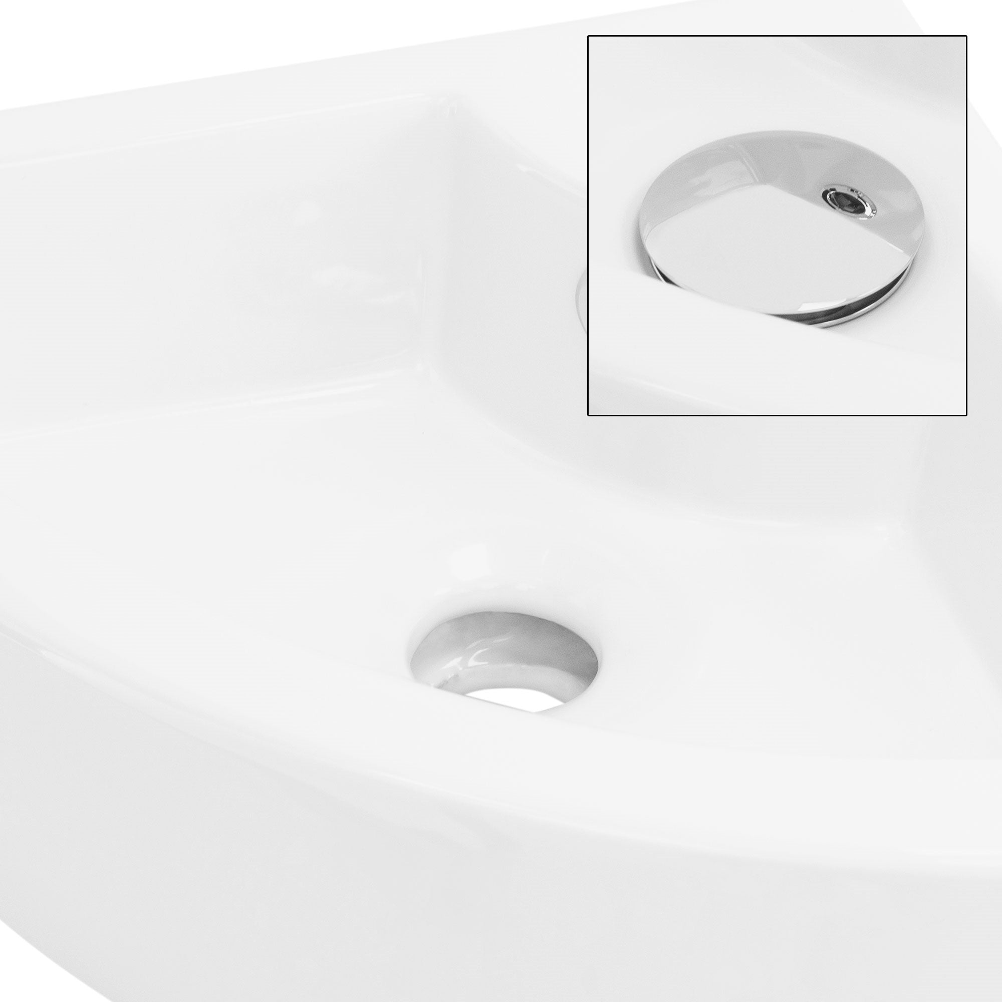 White sink with a round drain opening and shiny drain cover.