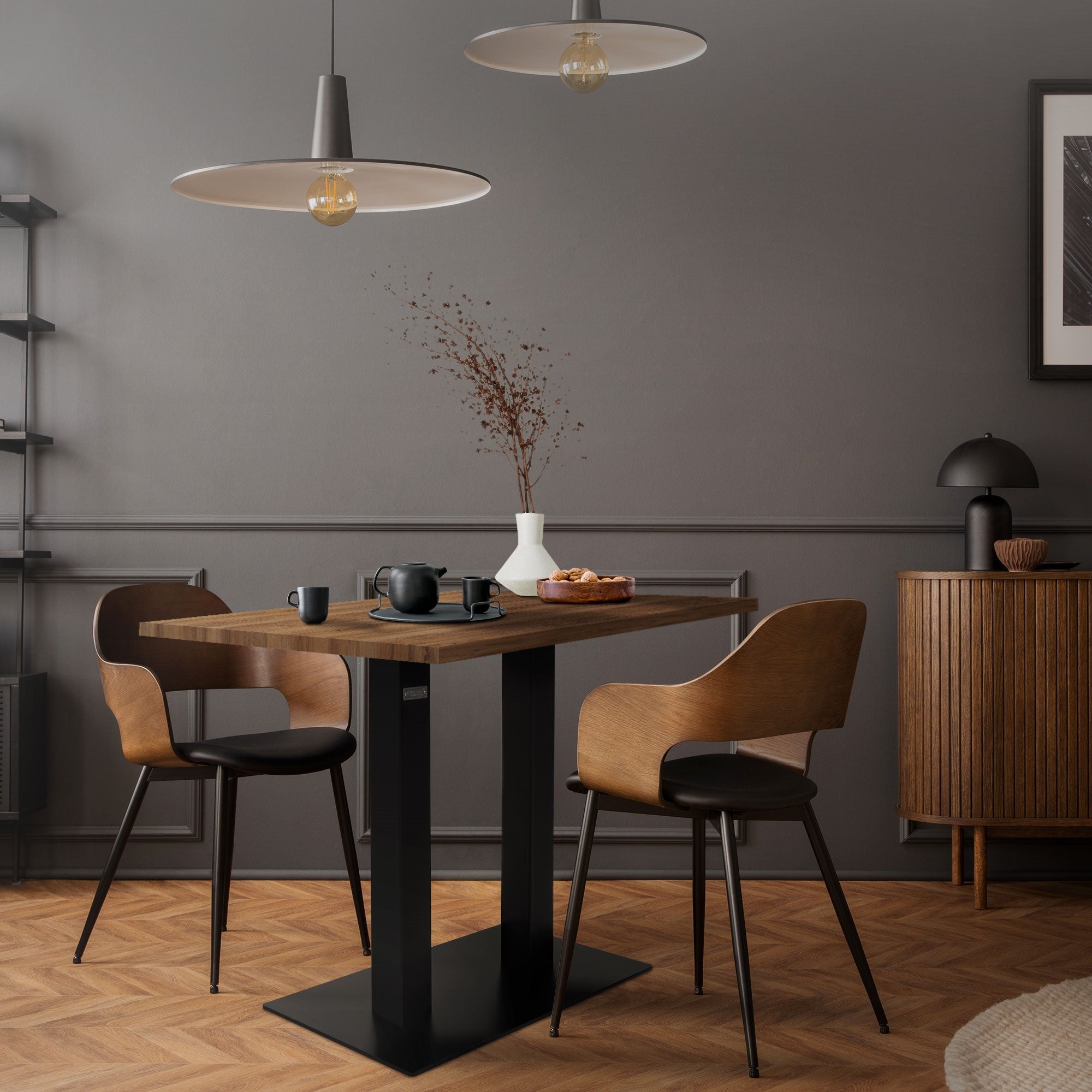 Dining area with wooden chairs, table, and a decorative vase.