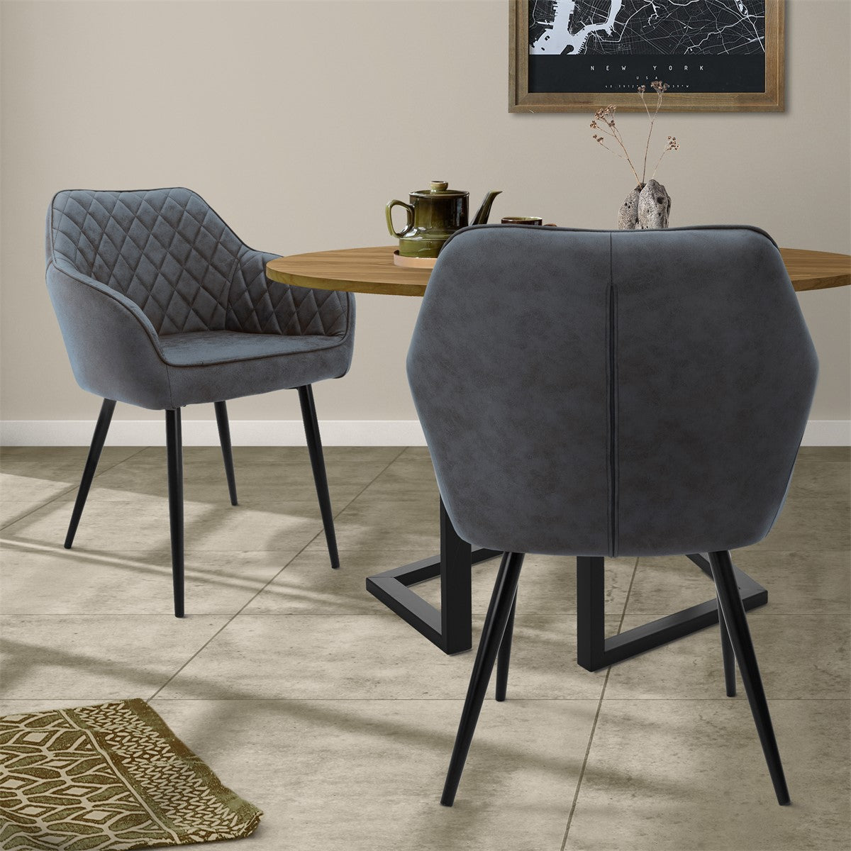 Two gray chairs at a round table with a teapot and a card.