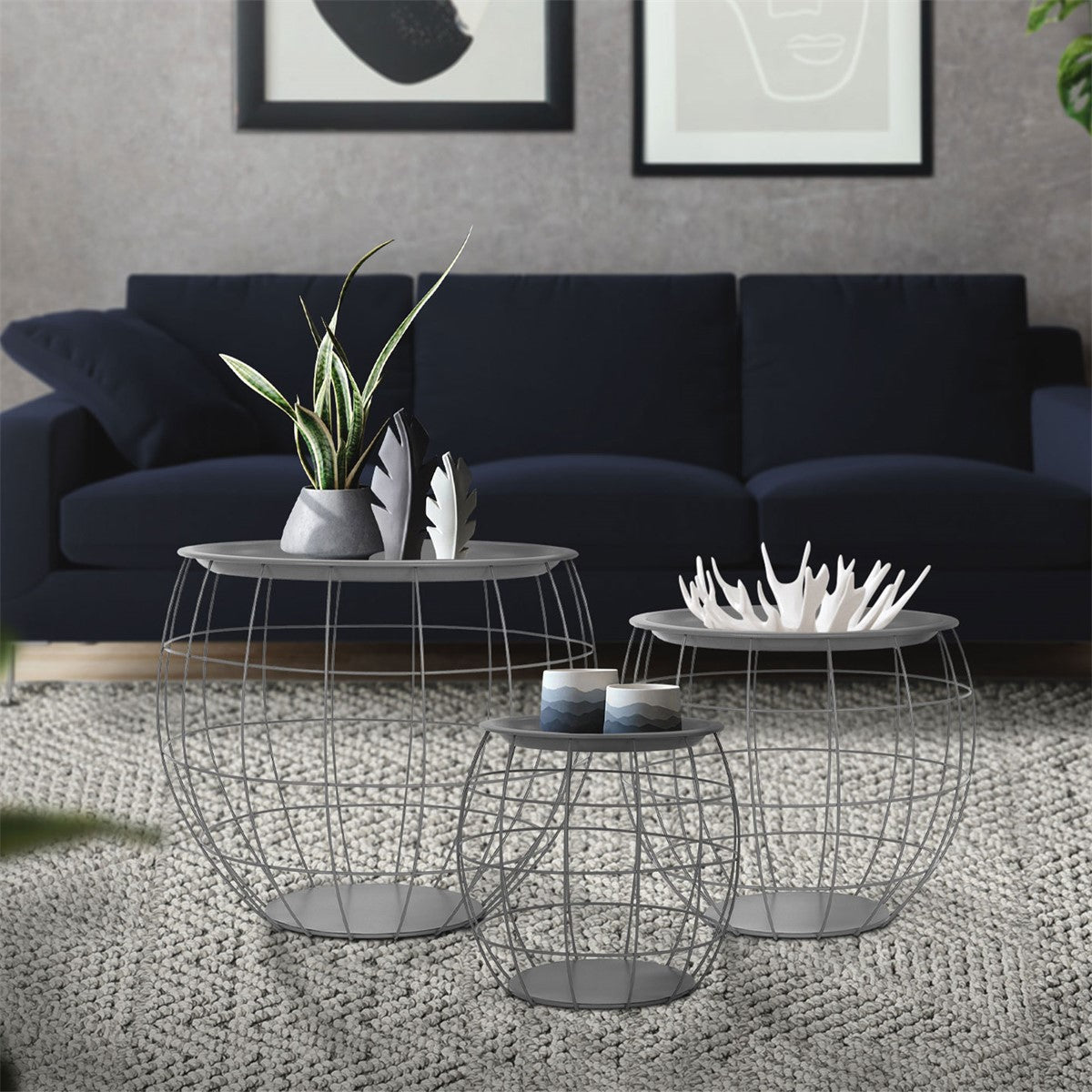 Three modern wire side tables with plants and decorations.