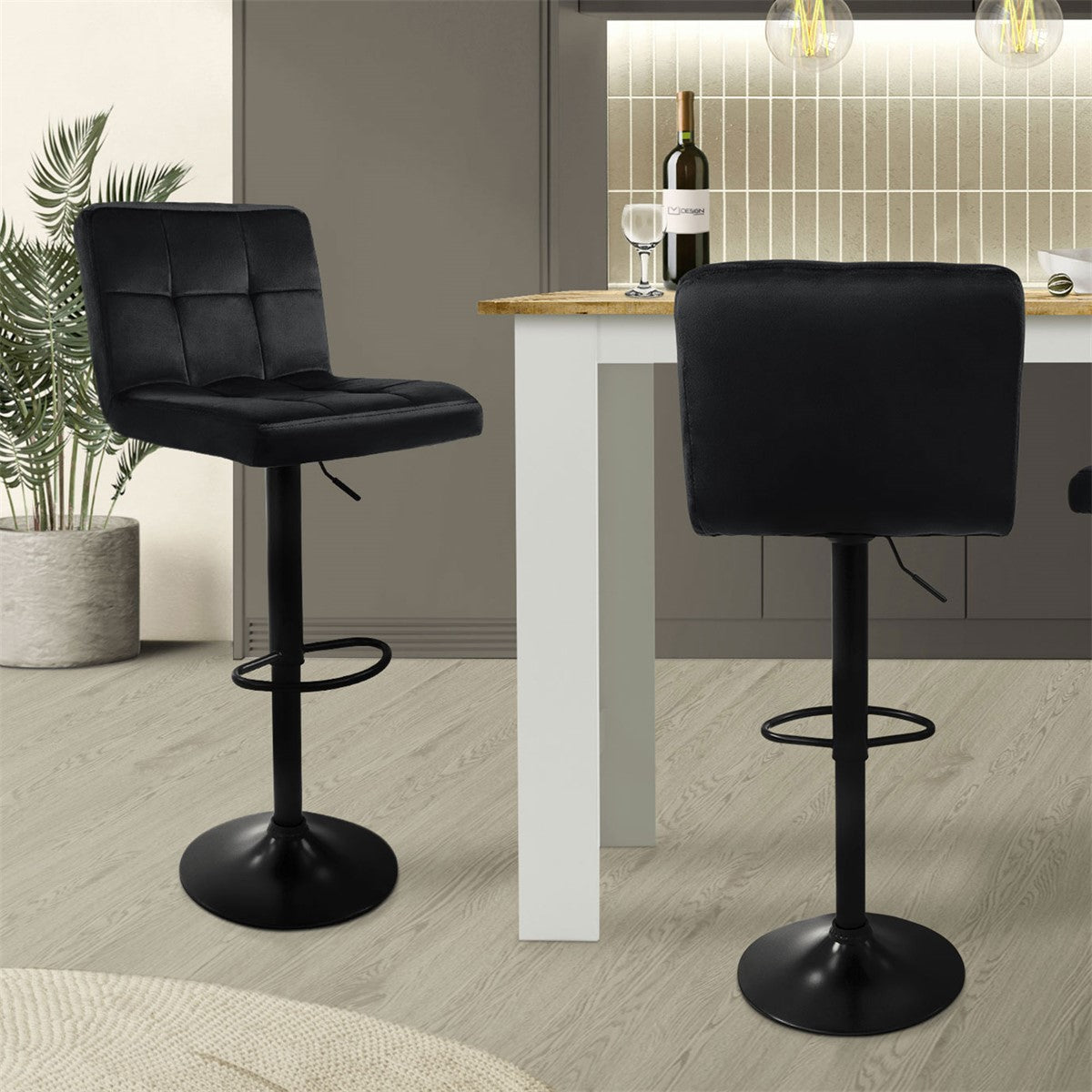 Two black bar stools at a table in a modern kitchen.