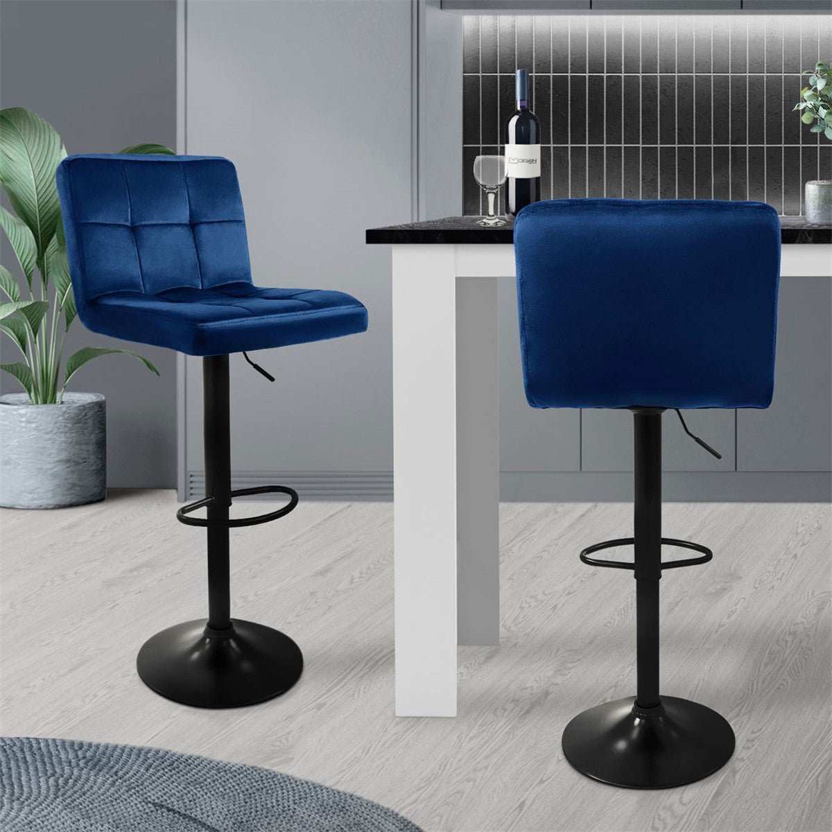 Two blue bar stools at a table in a modern kitchen.