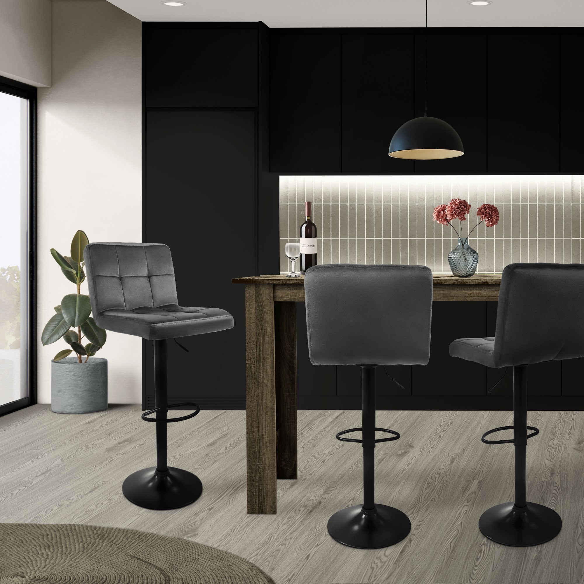 Modern kitchen with bar stools, table, and plants in the background.