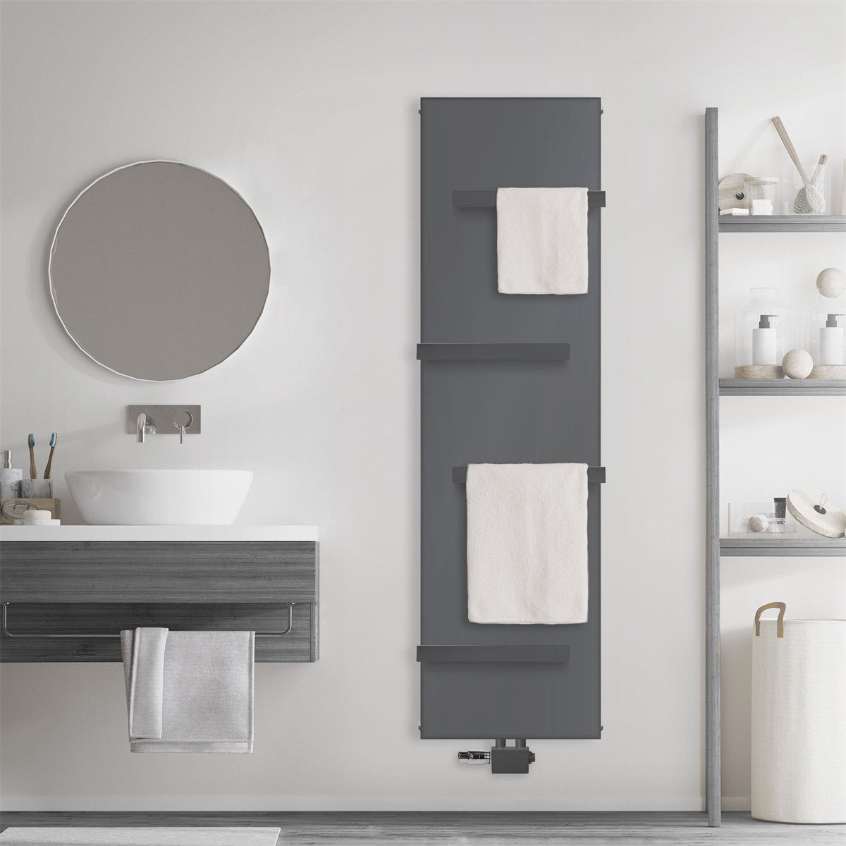 Anthracite-colored radiator on a wall with two towel rails and towels.