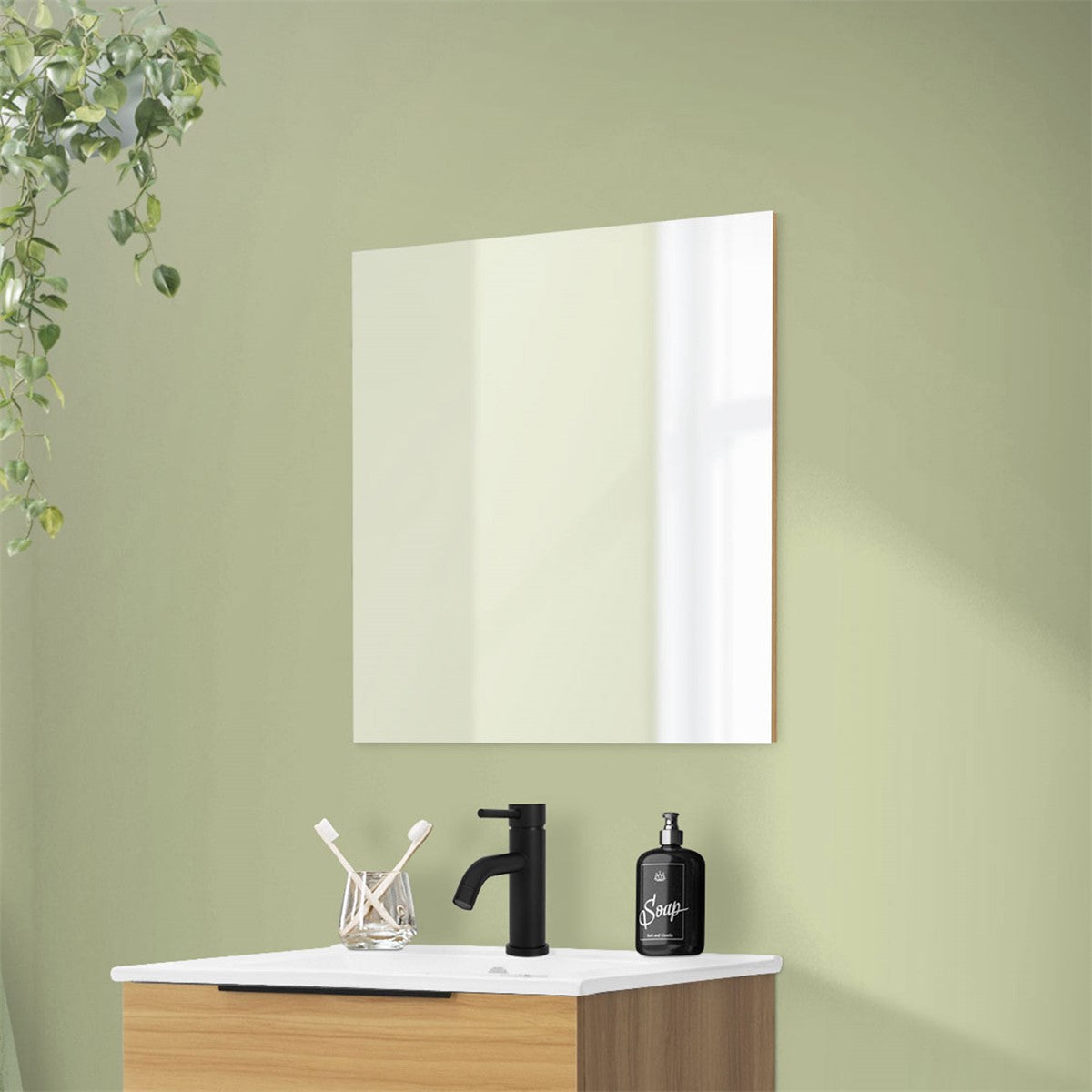 Mirror above a wooden washbasin with a black faucet.
