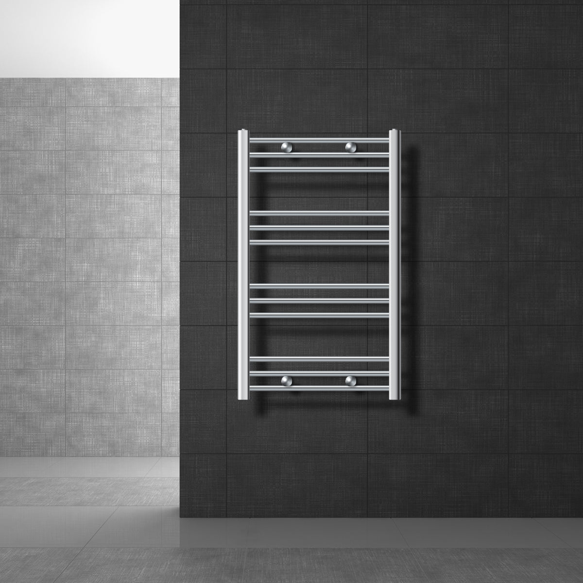 A small towel radiator made of stainless steel on a dark wall.
