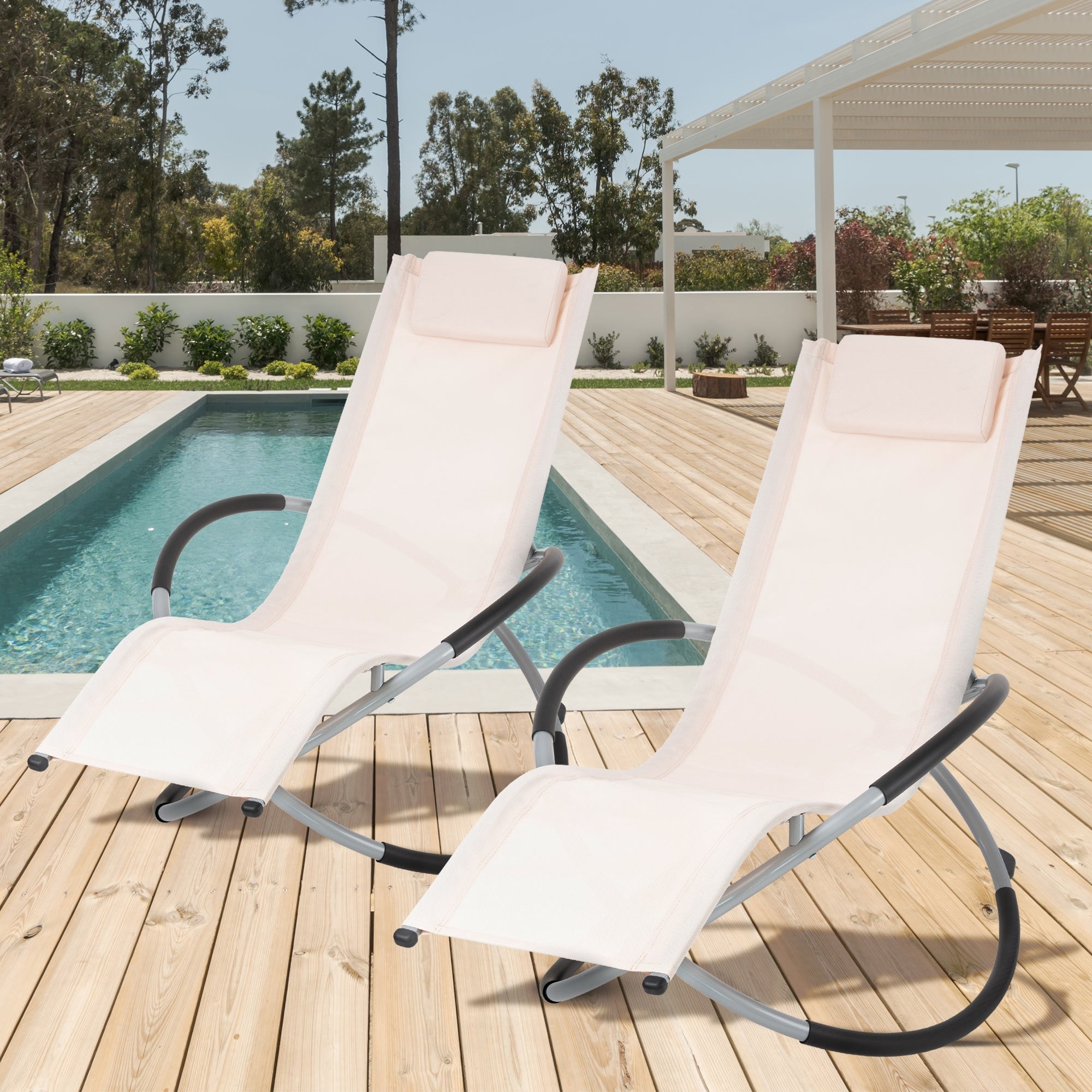Zwei Liegen stehen neben einem Pool auf einer Holzterrasse.