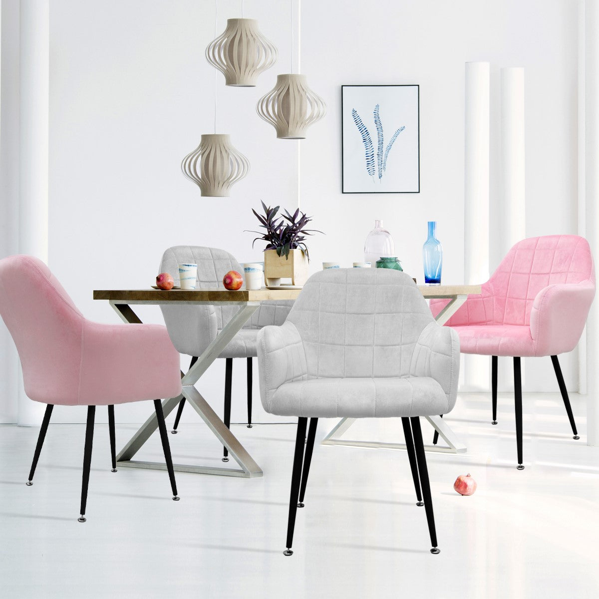 Dining room with a table and chairs in various colours, decorated with fruit.