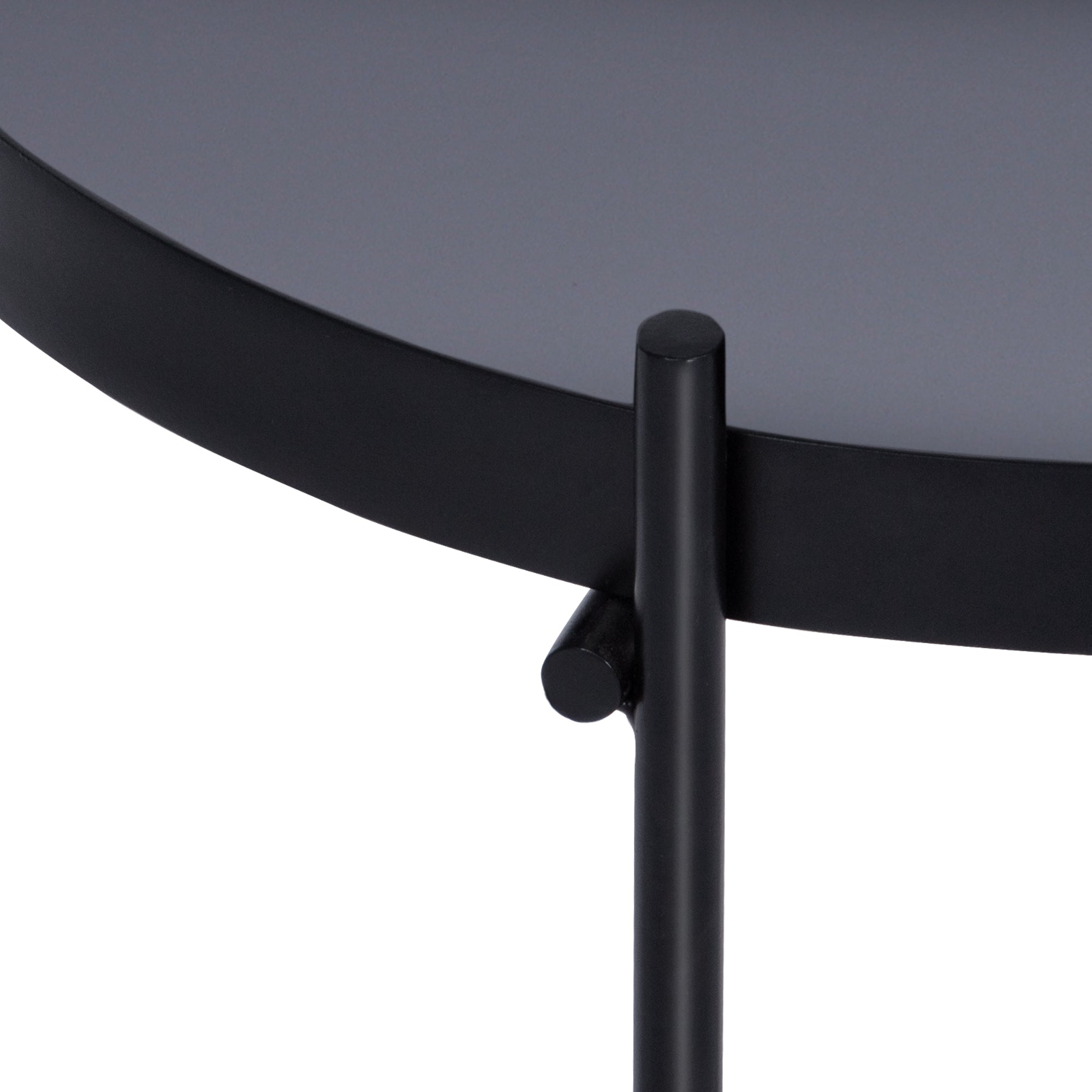 Close-up of a round black table with a sturdy frame.