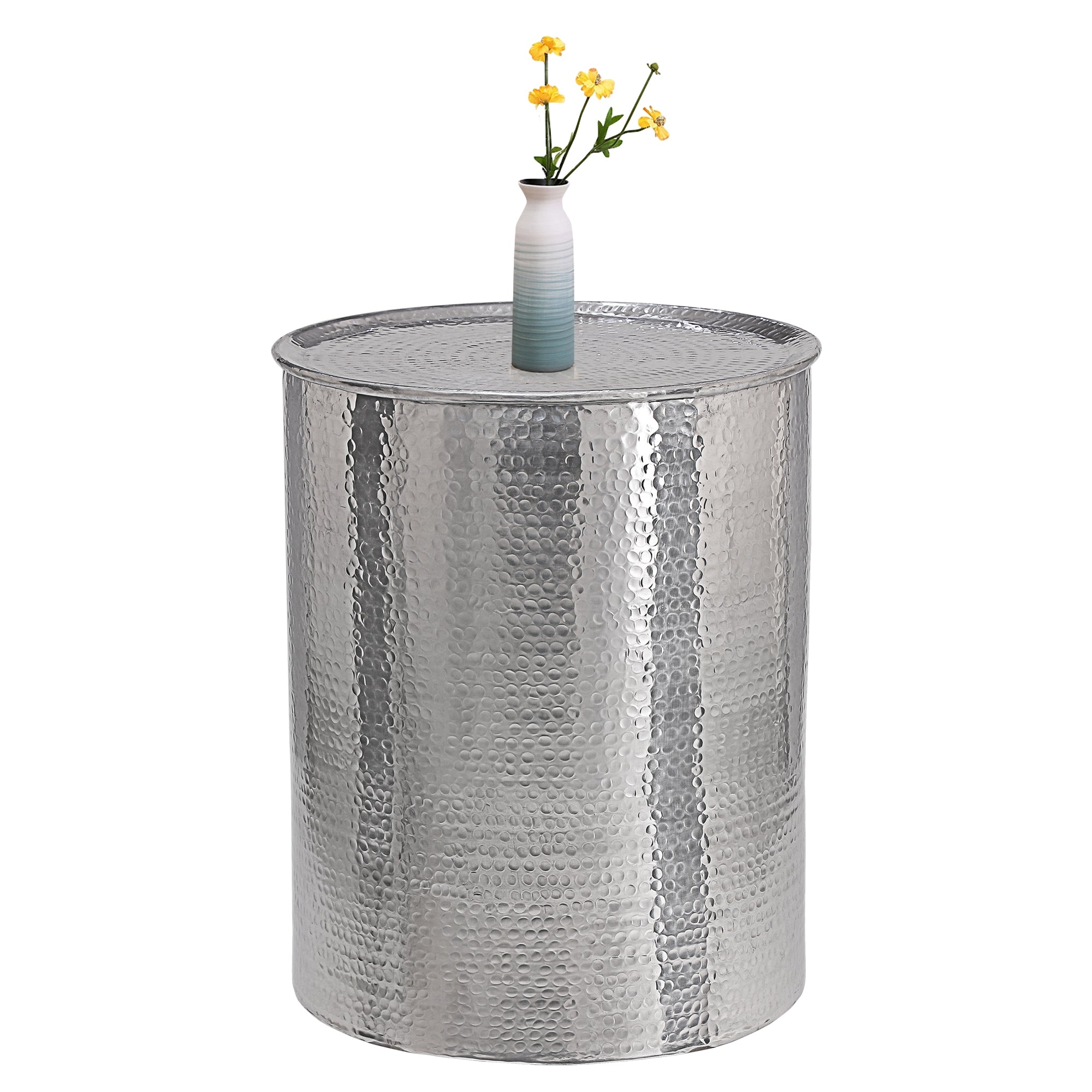 Silver table with a wavy surface and a vase with flowers in the center.