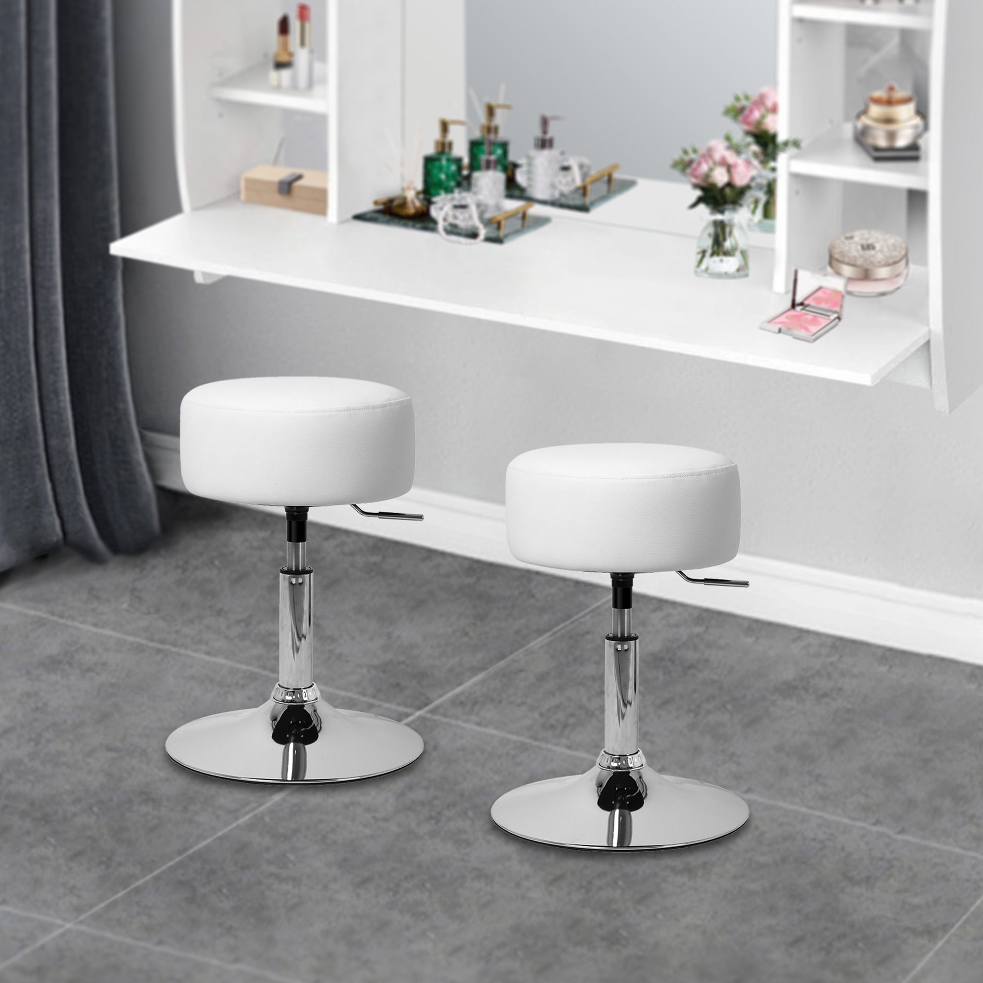 Two white bar stools with round seat in front of a mirror and a white shelf.