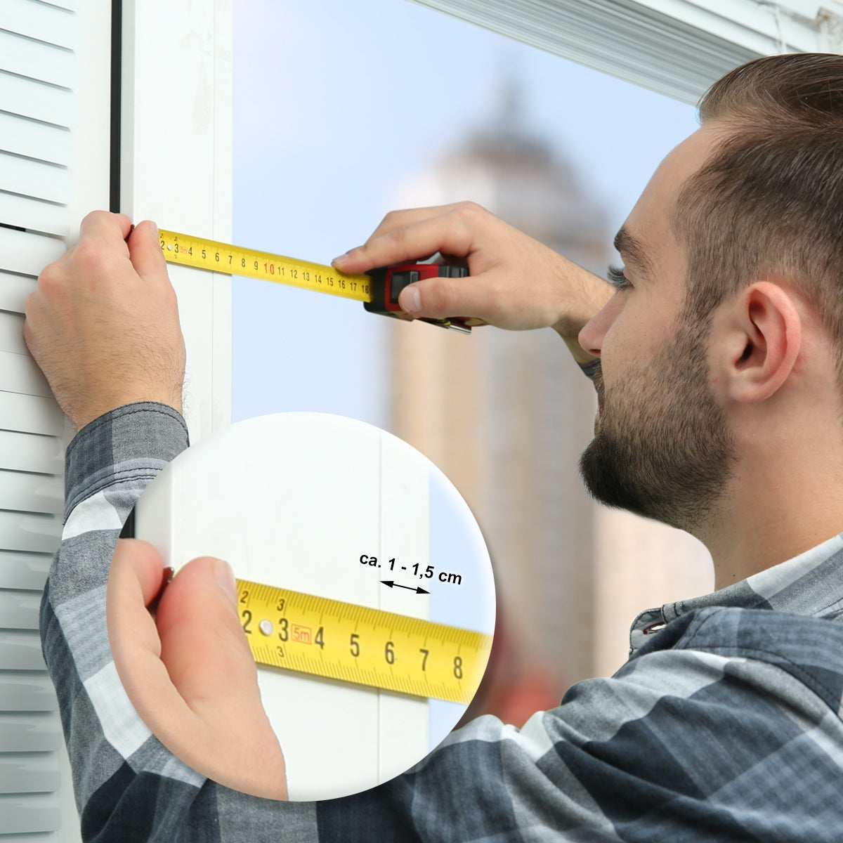 Man measuring the width of a blind at a window with a tape measure.
