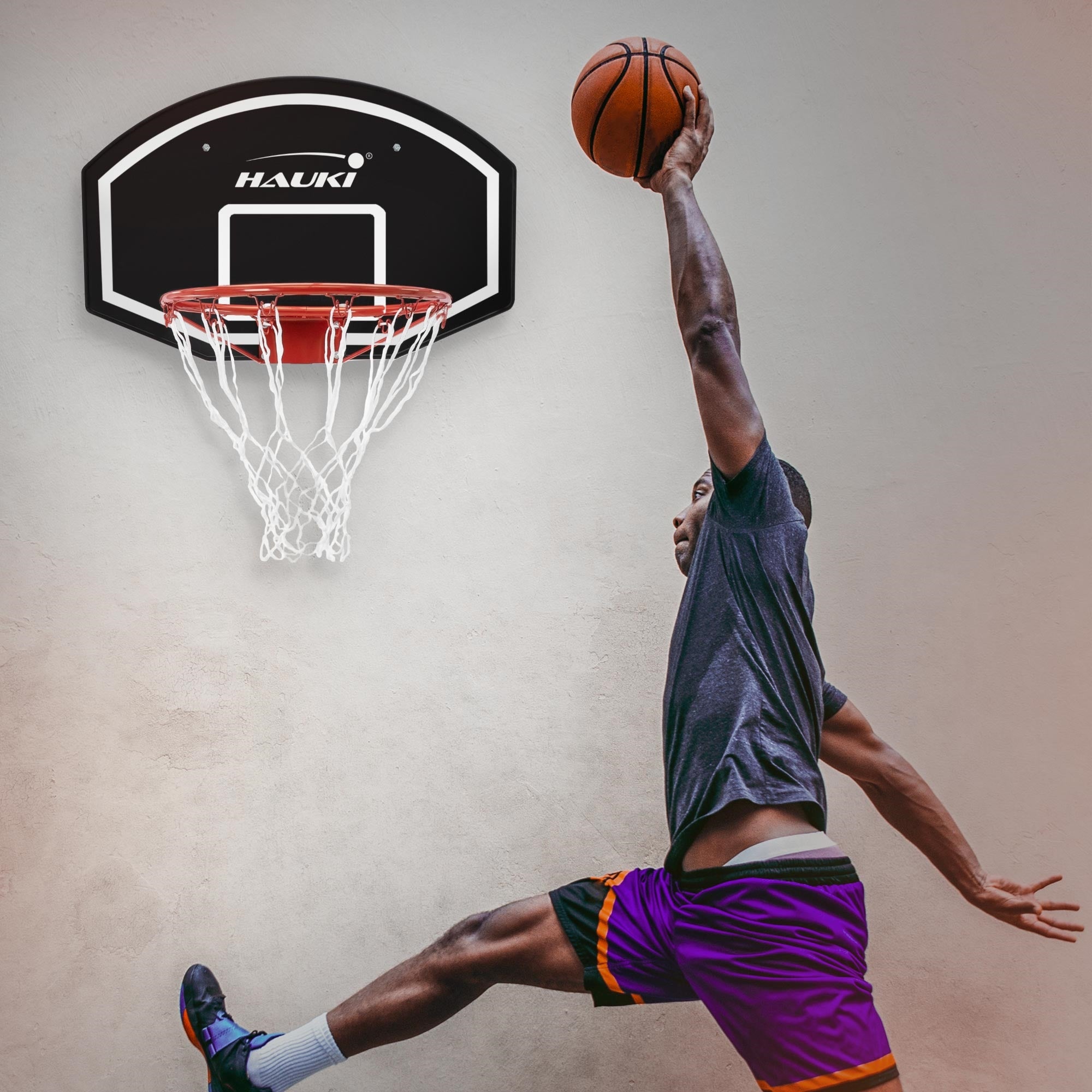 Player jumps to throw a basketball into the hoop.