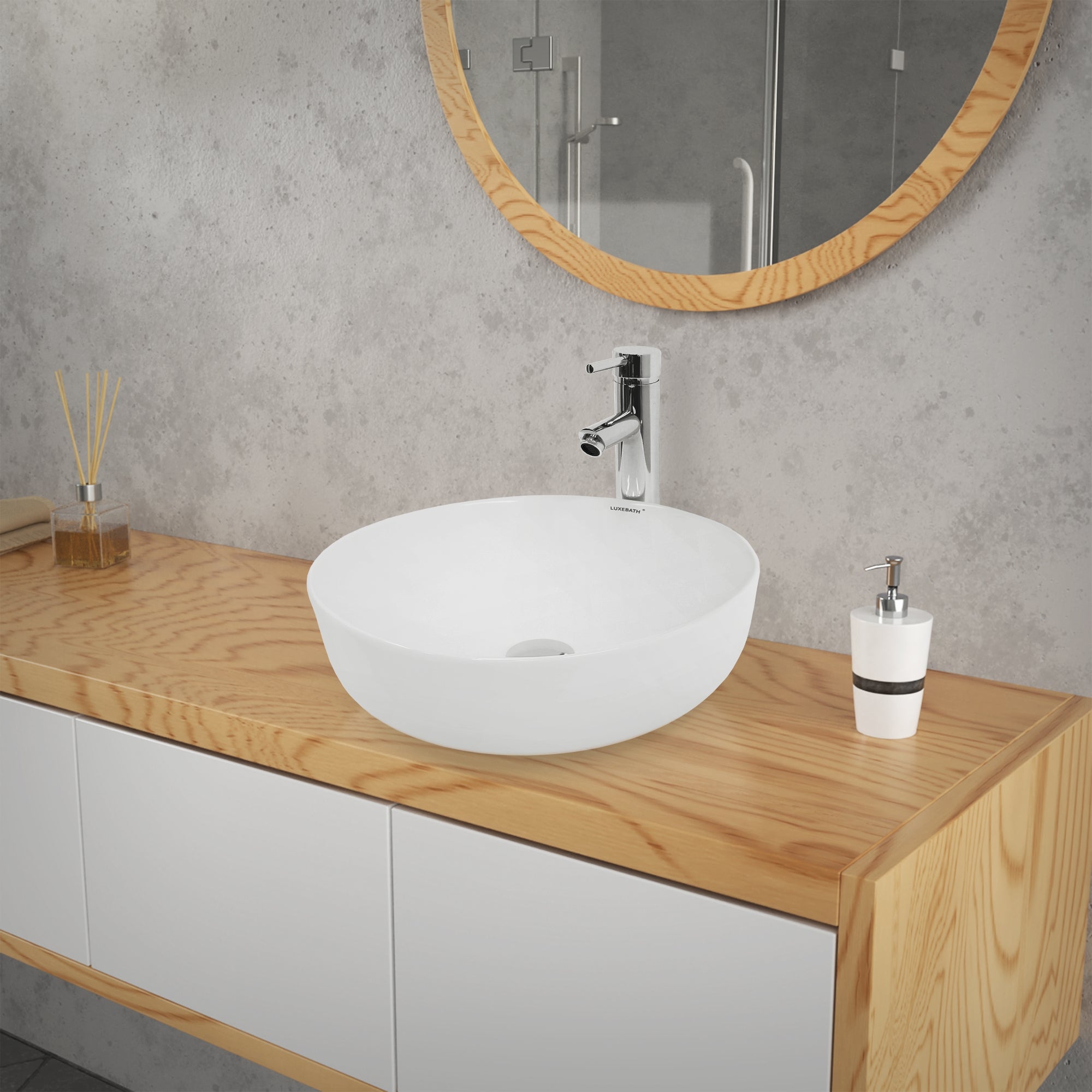 Washbasin on a wooden cabinet with a mirror in the background.