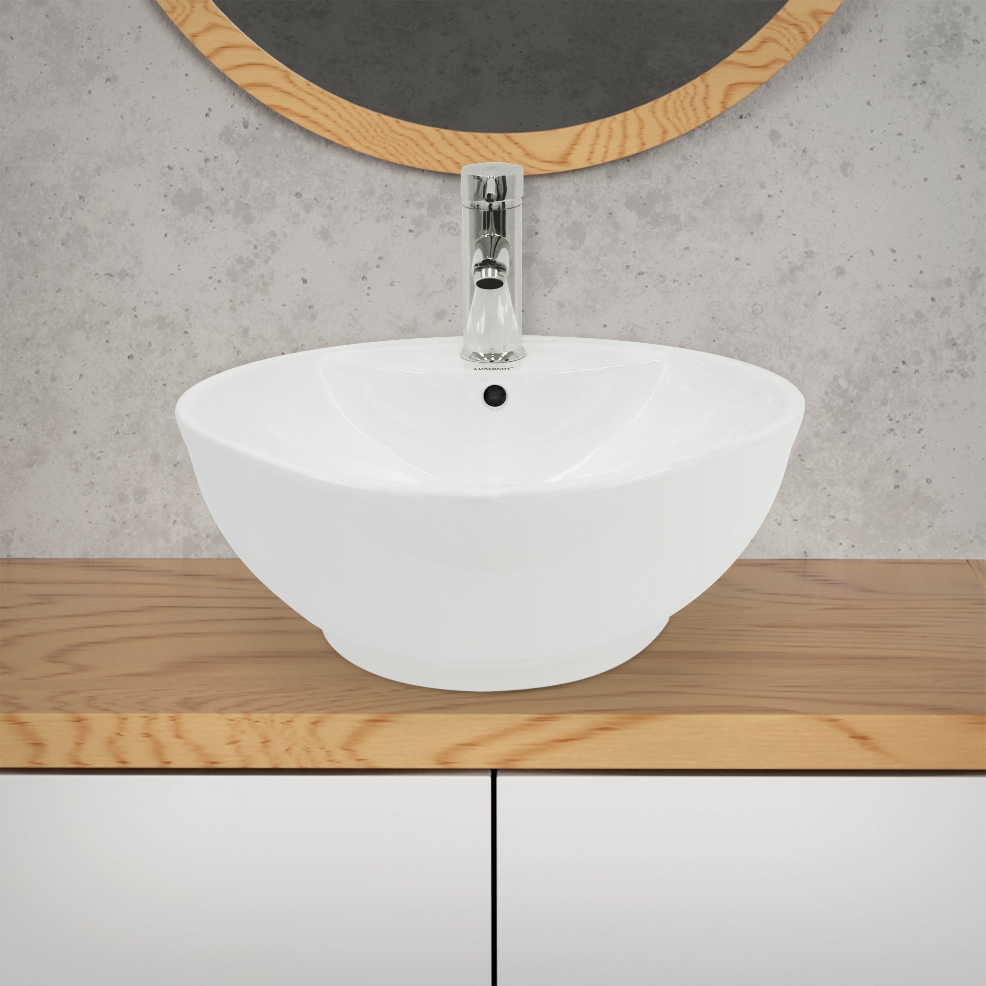 White, round sink on a wooden cabinet.