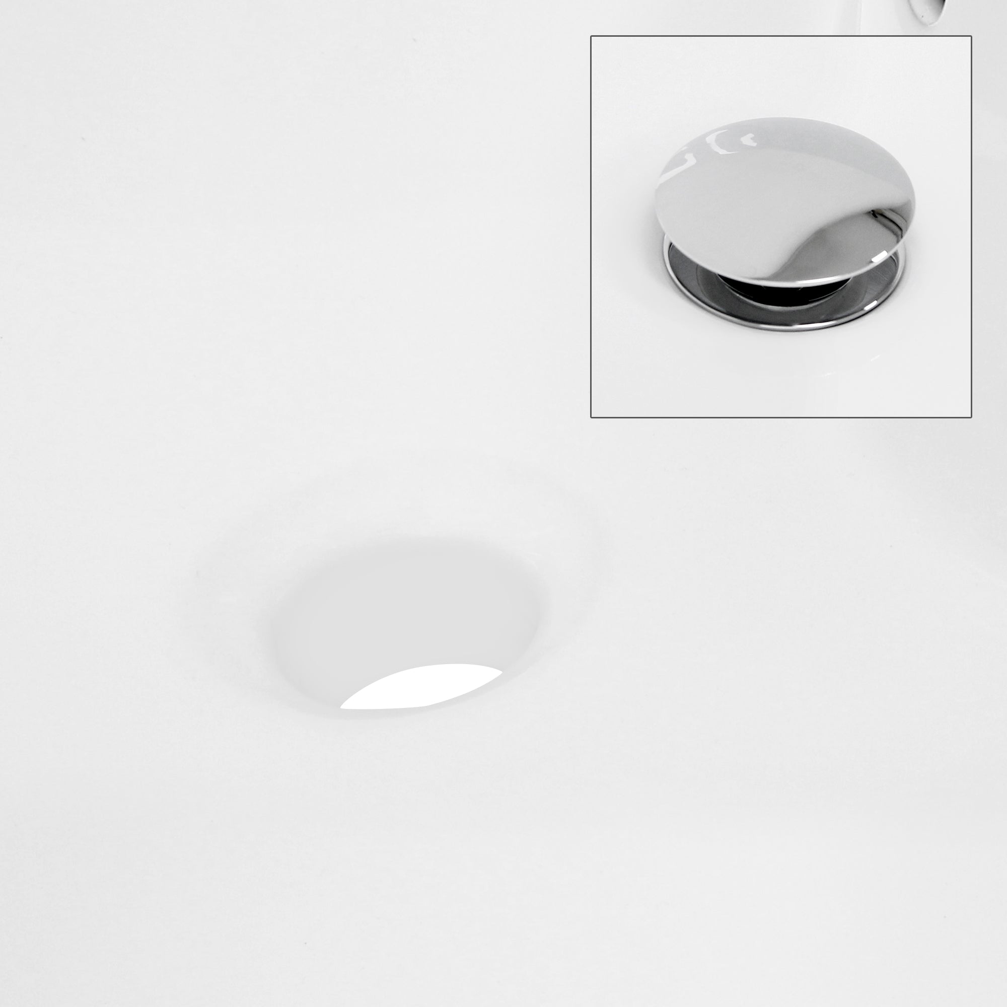 Close-up of a sink with drain opening and valve.