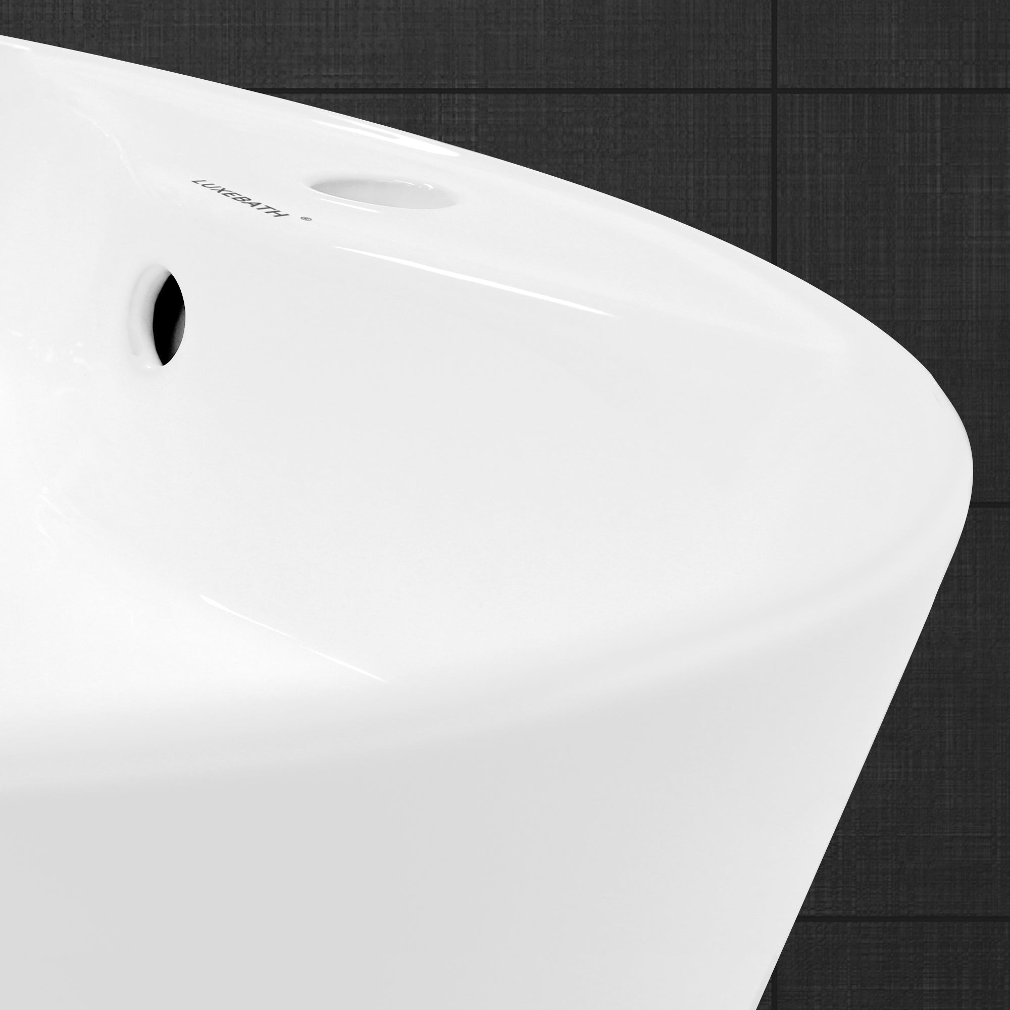 Close-up of the edge of a white sink on a dark background.