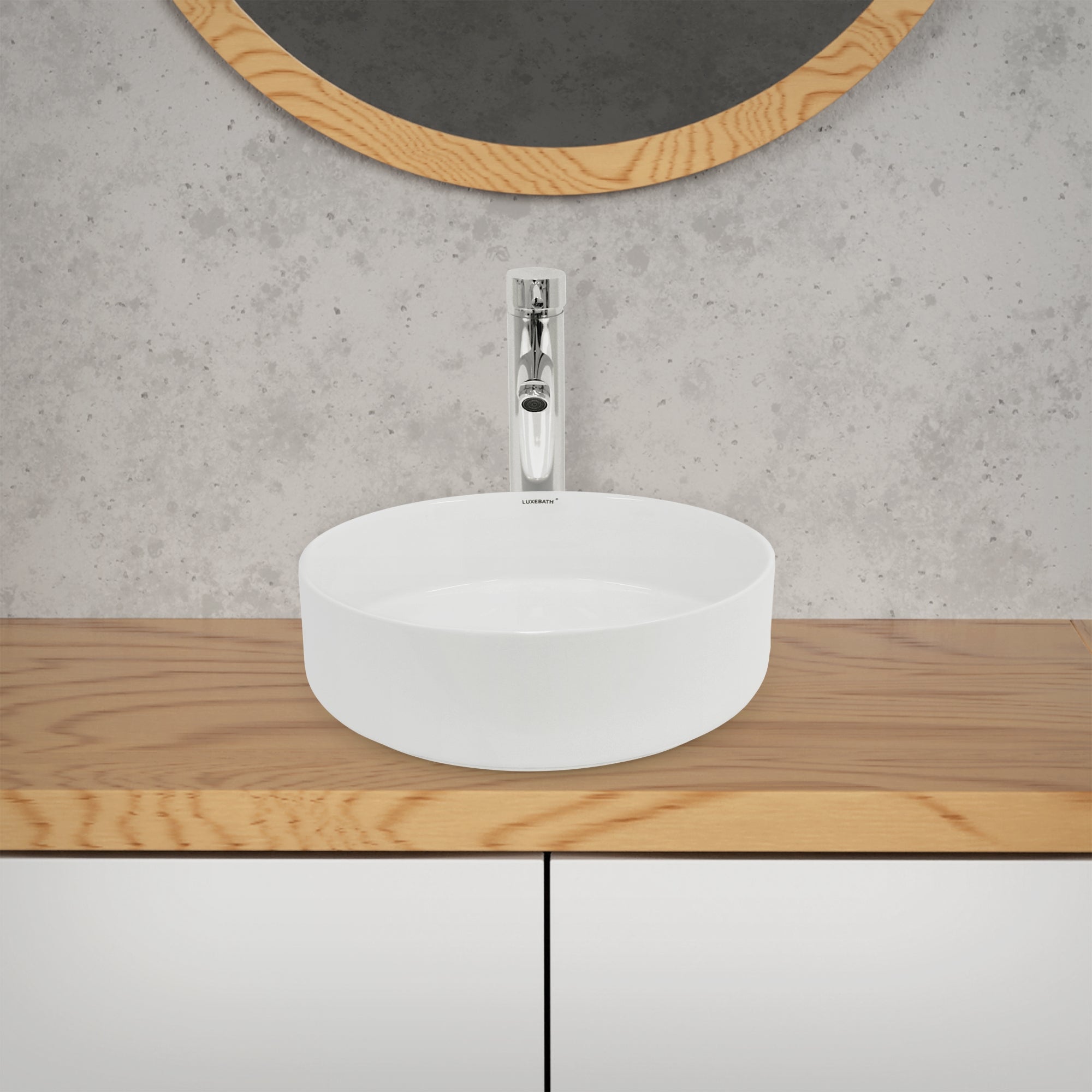 Round sink on a wooden dresser in front of a mirror.