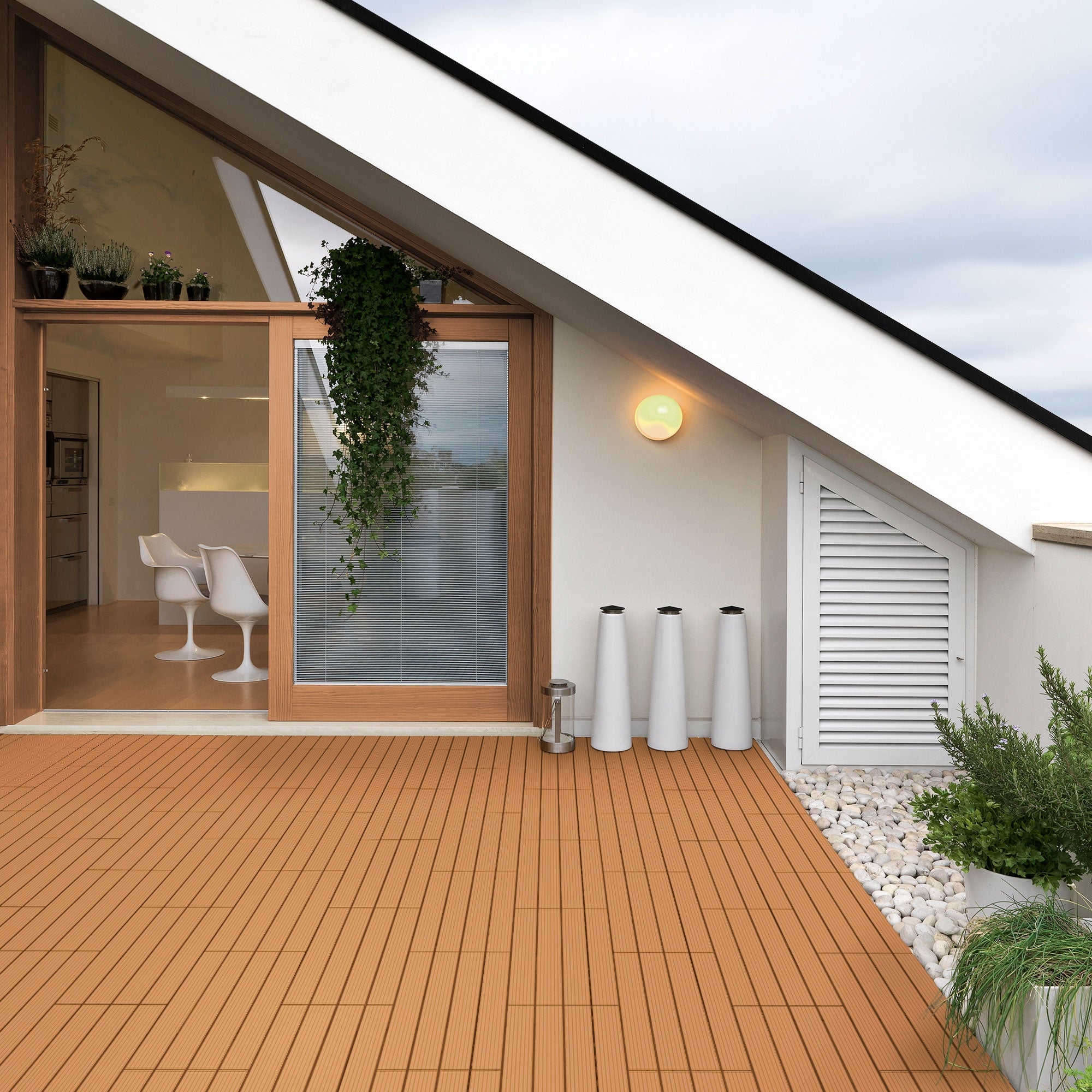Terrace with WPC boards, modern furniture, and plants in a bright room.