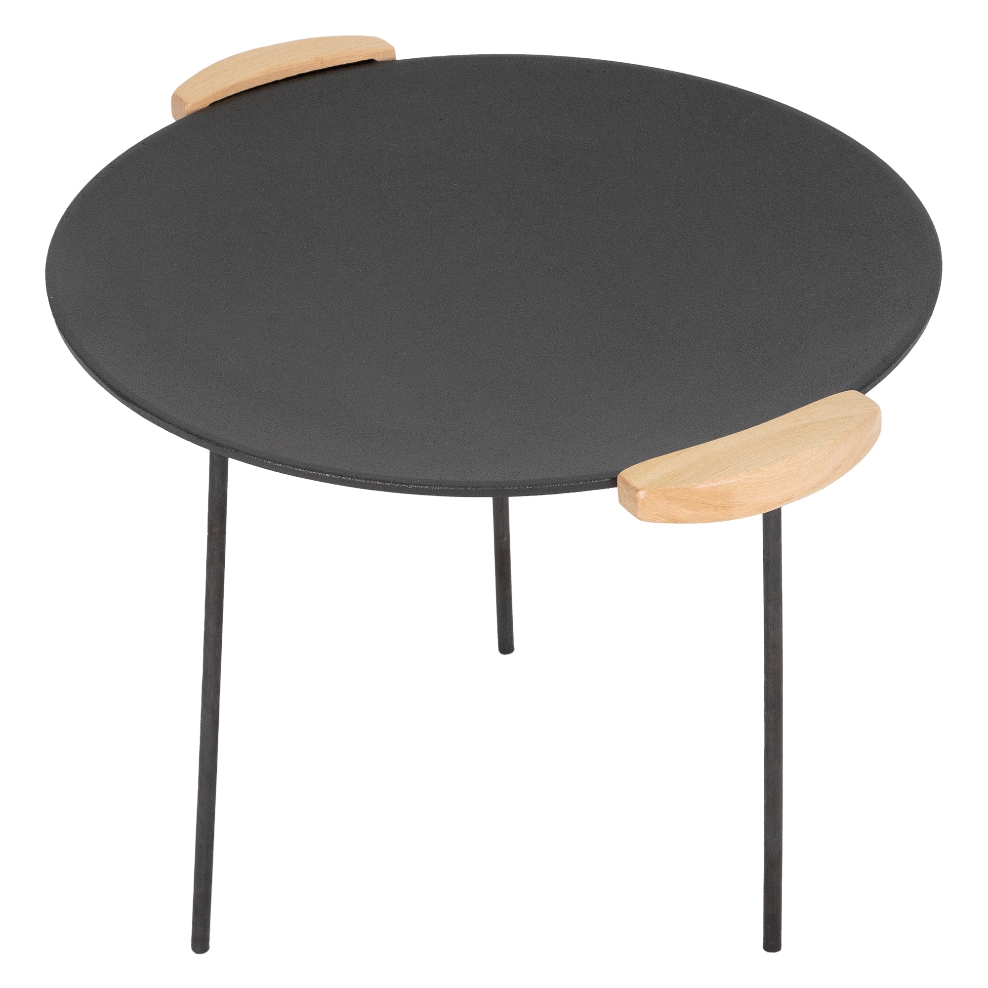 Round table with a black top and wooden handles.