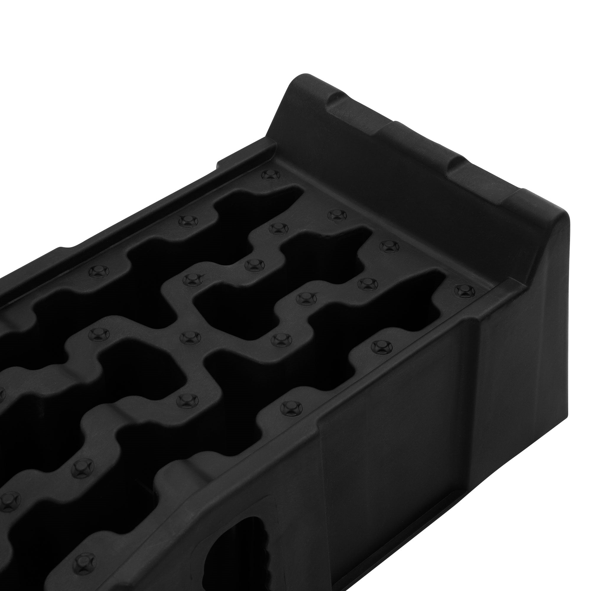 Schwarze Gummimatte mit strukturiertem Muster und Schrauben.