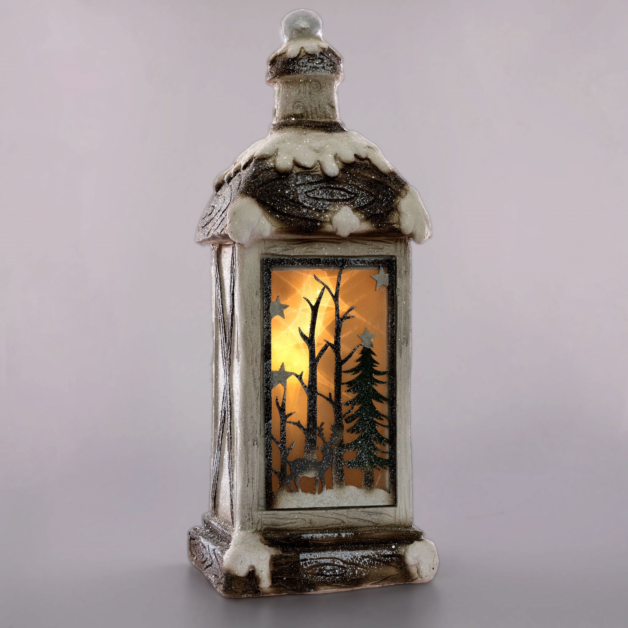 Dekorative Laterne mit winterlichem Motiv und beleuchtetem Innenraum.