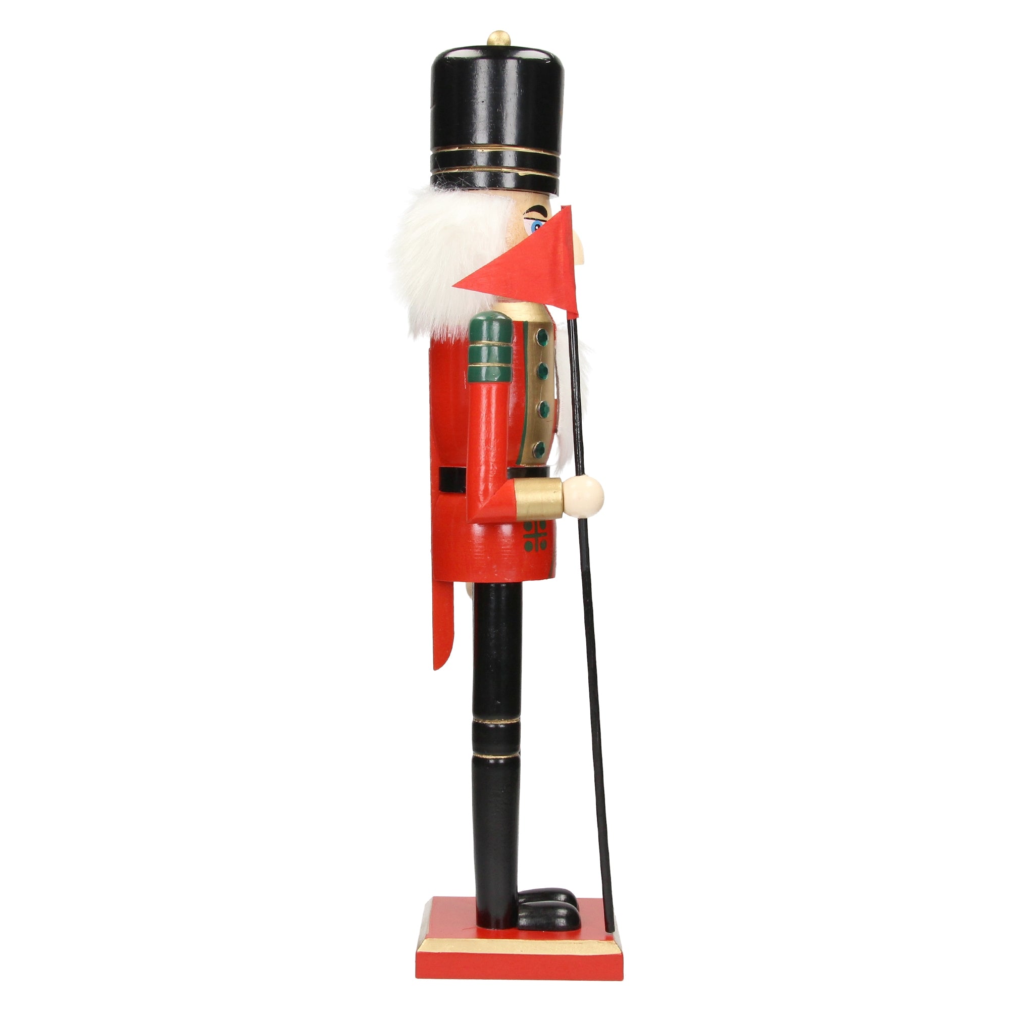Side view of a nutcracker with a red cape and a flag.