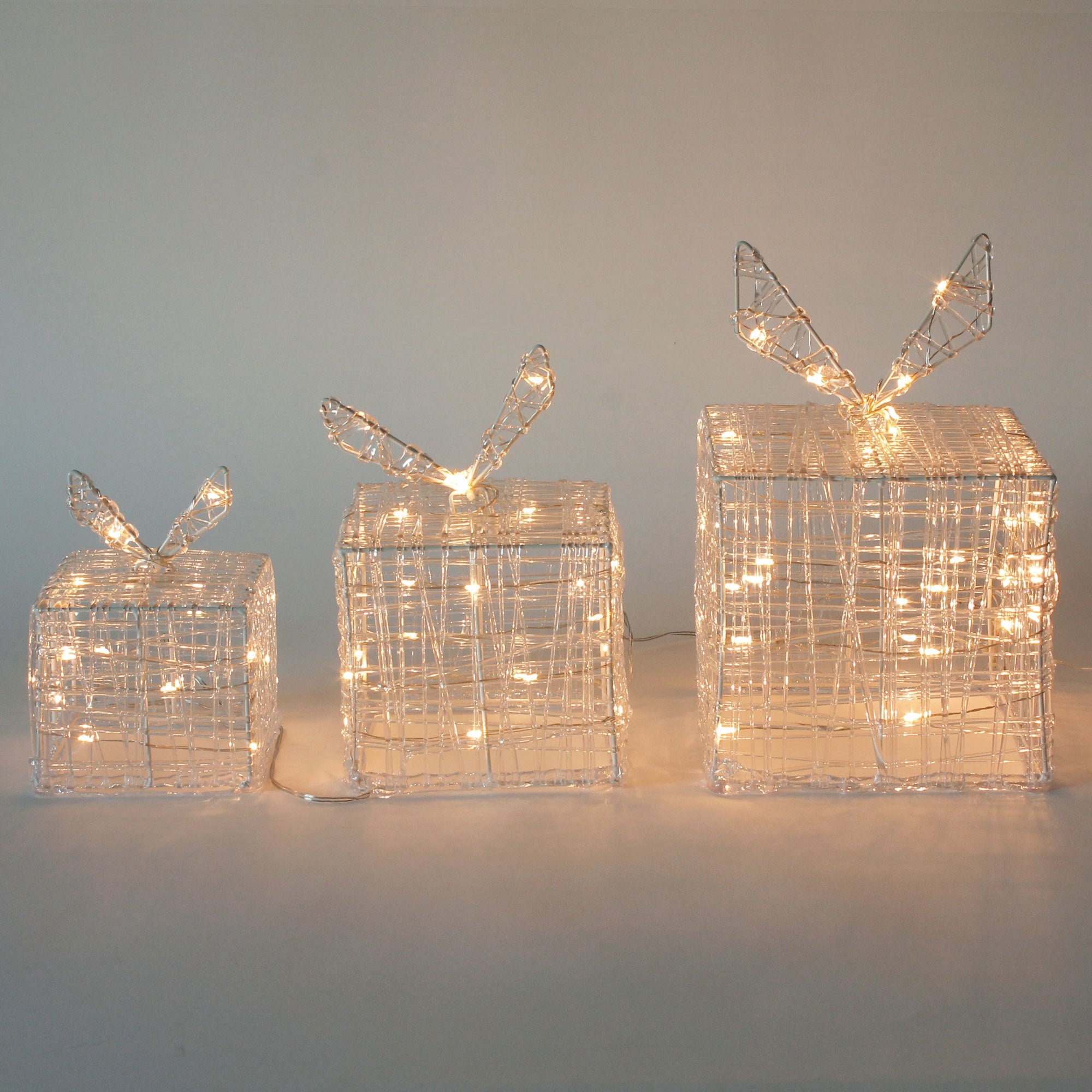 Three glowing gifts with wire and wings.