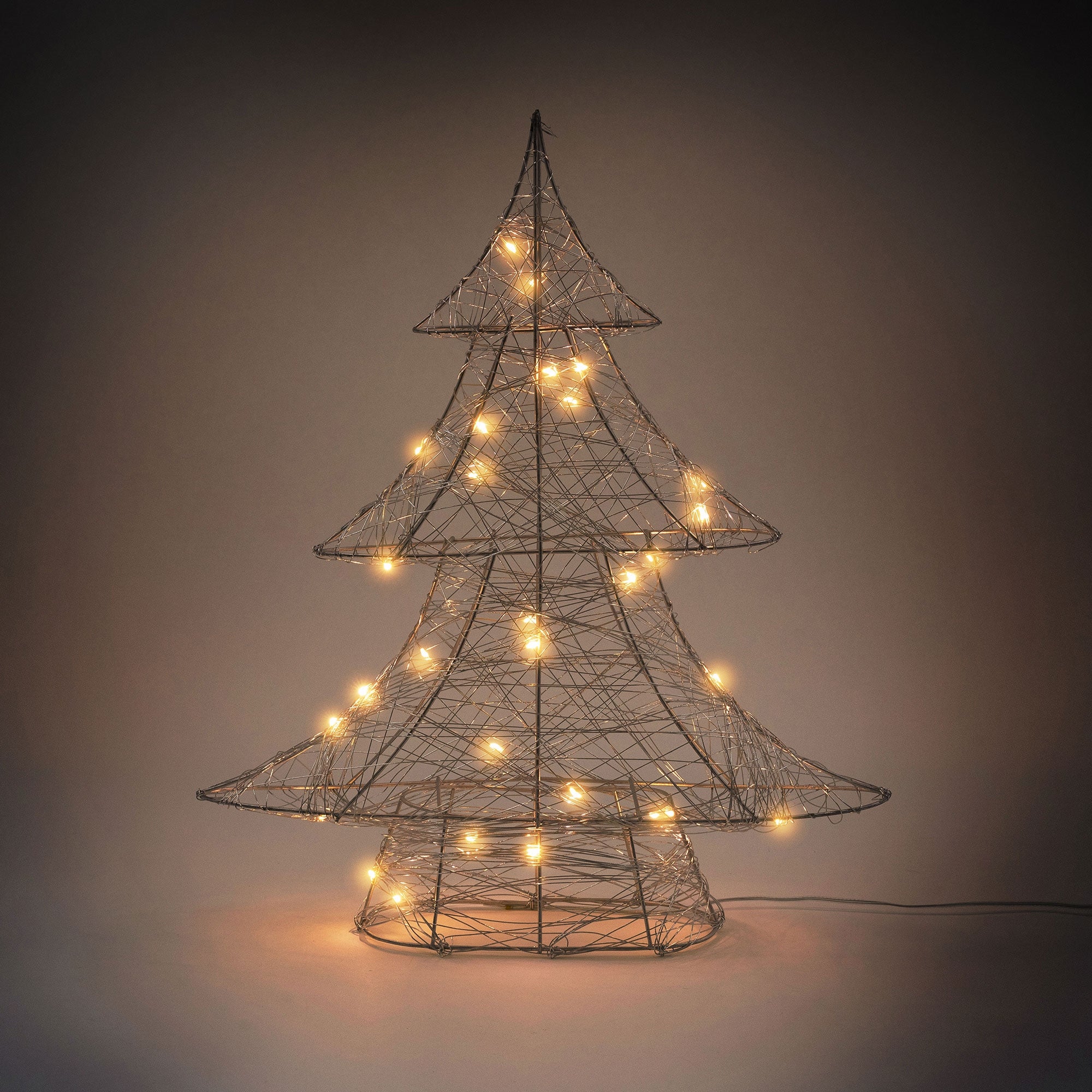 Wire tree with lights on a dark background.