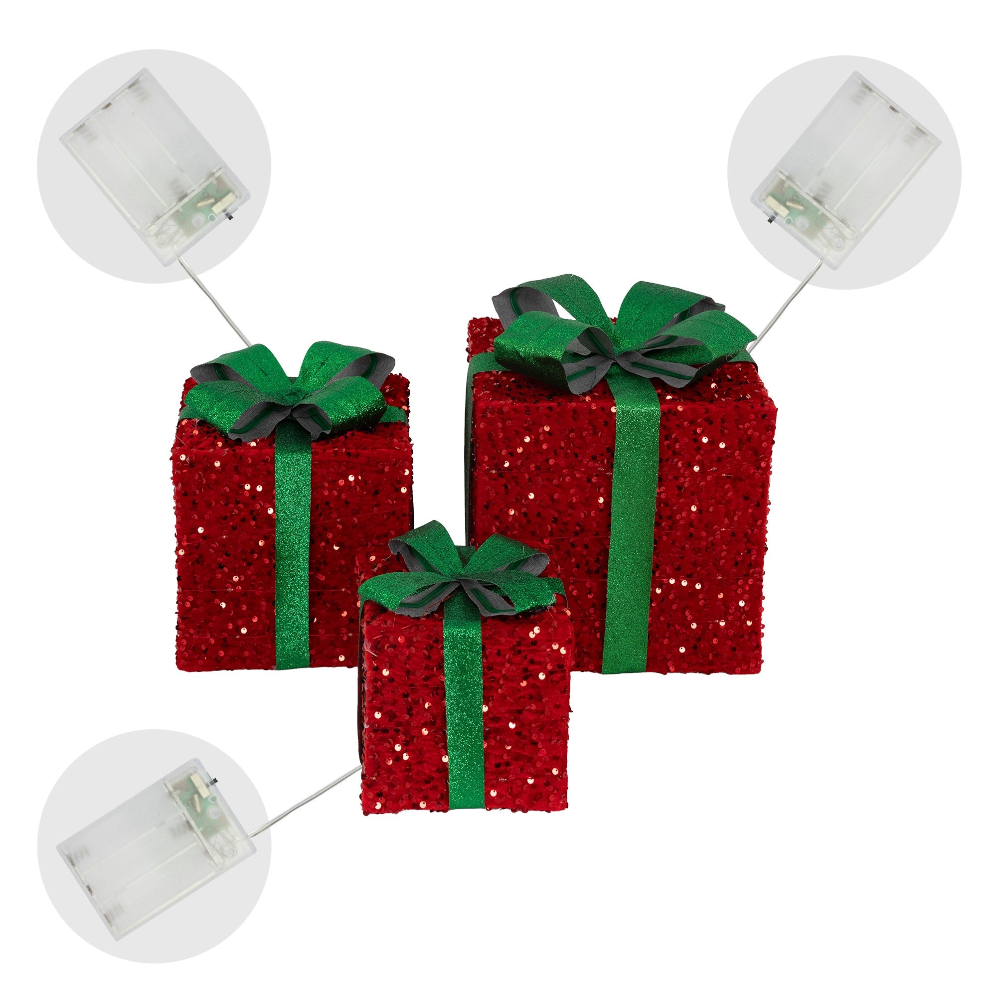 Drei glitzernde Geschenke in Rot mit grünen Schleifen.