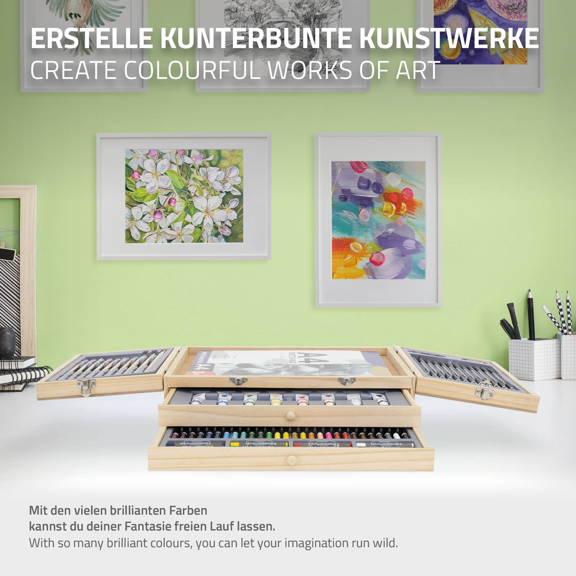 Ein offenes Kunstset mit vielen Farben und einem Blatt Papier auf einem Tisch.