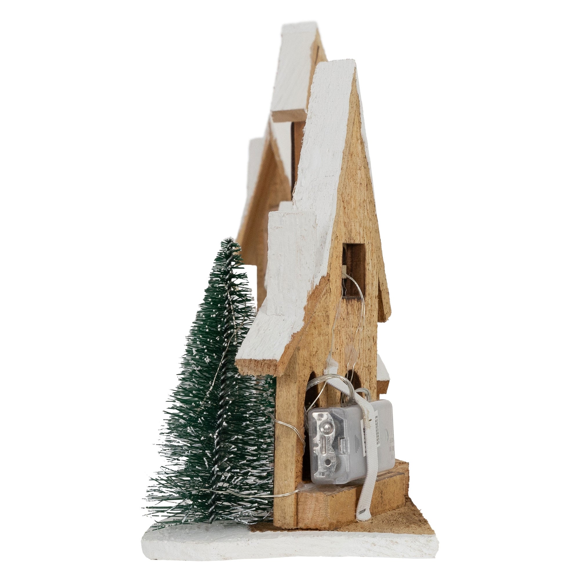 Side view of a wooden house with a fir tree and a battery box.