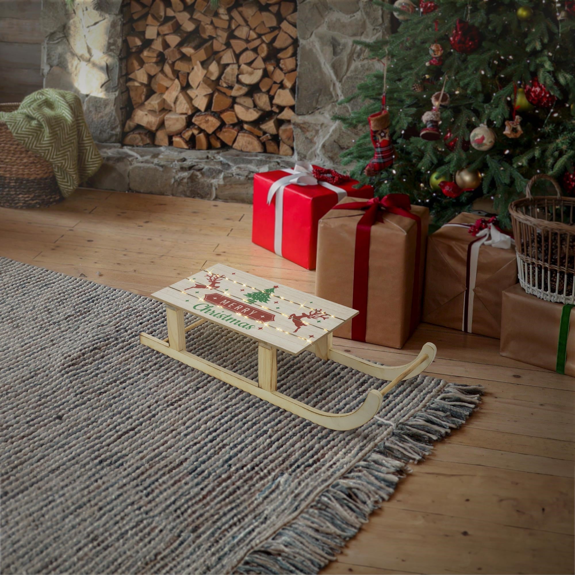 Wooden sled in front of a Christmas tree and gifts in a cozy room.