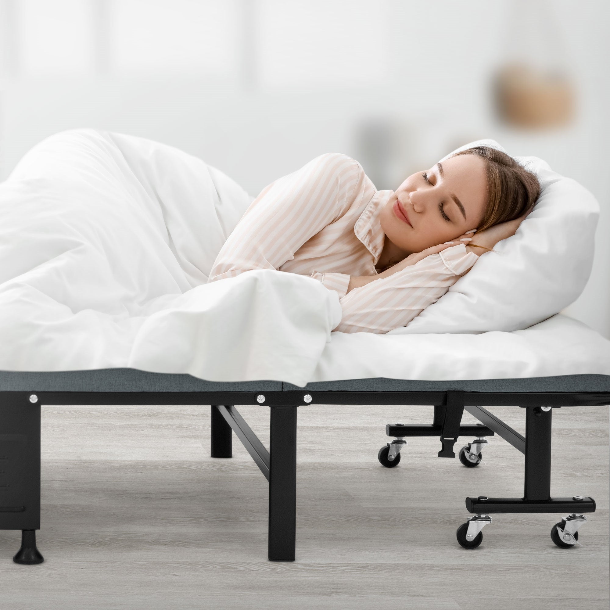 Schlafende Person auf einem Bett mit weißer Decke, in heller Umgebung.