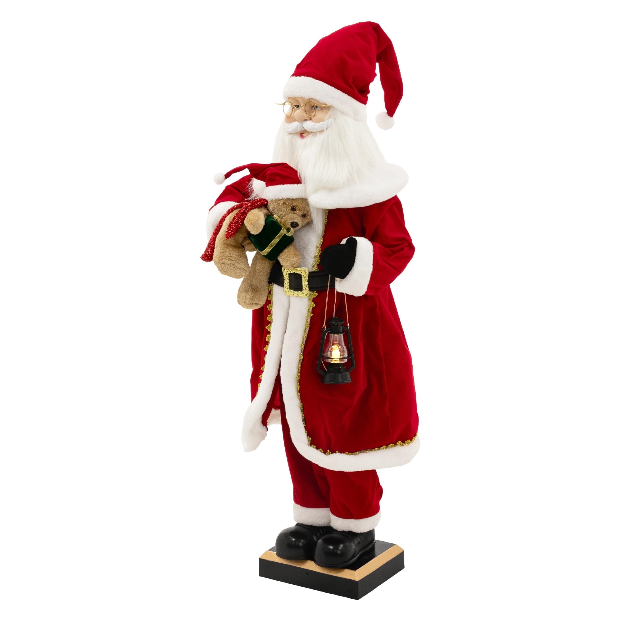 Ein Weihnachtsmann mit einem Bären und einer Laterne in rotem Gewand.