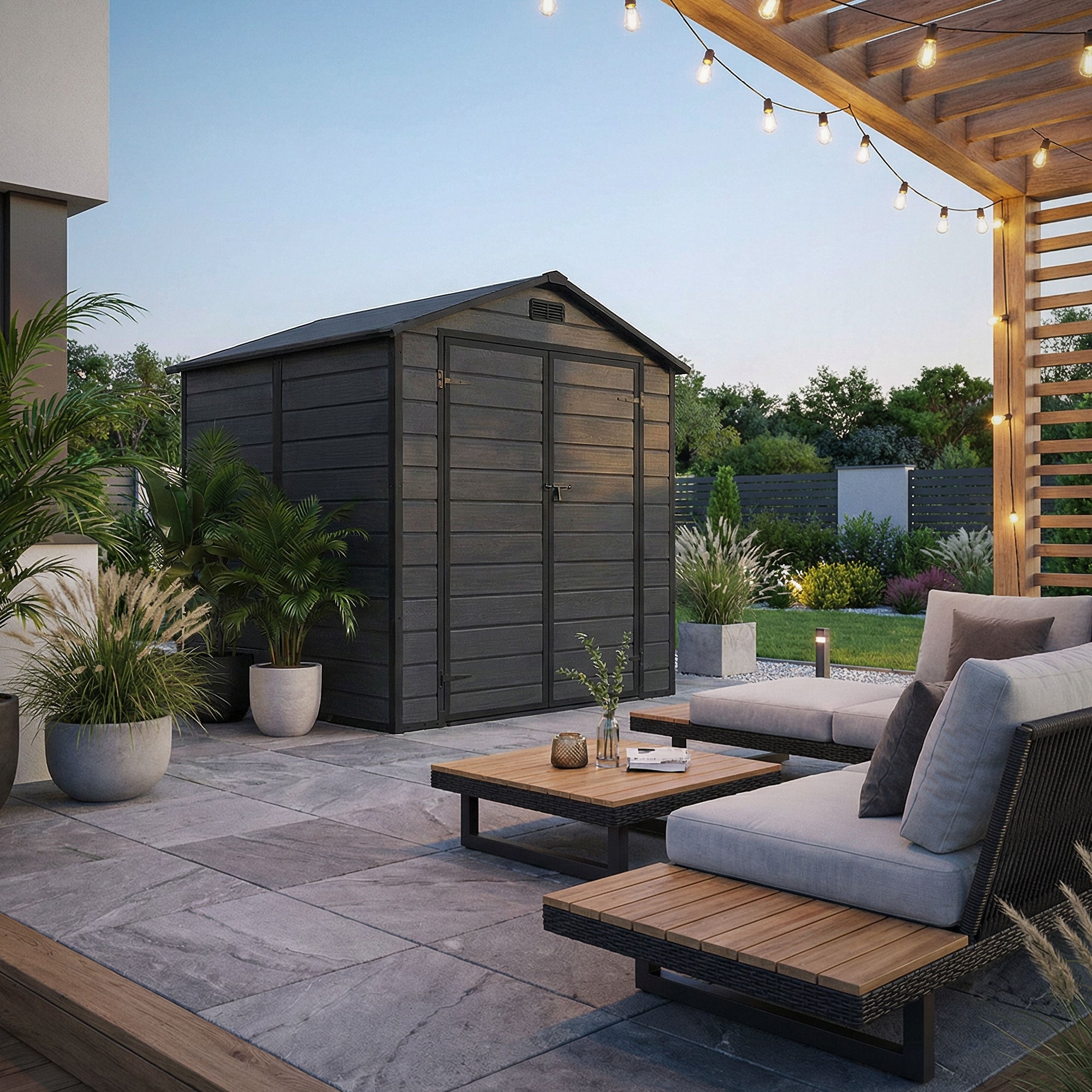 Wooden shed in the garden, surrounded by plants and a terrace with seating.