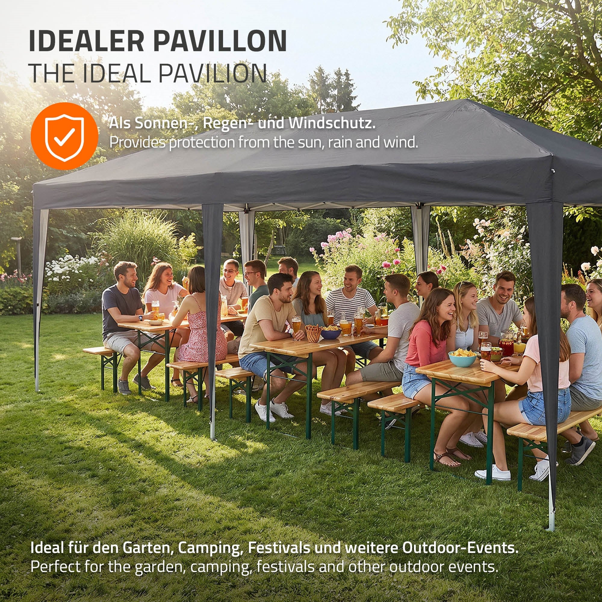 Group of people sitting at tables under a pavilion in the garden.