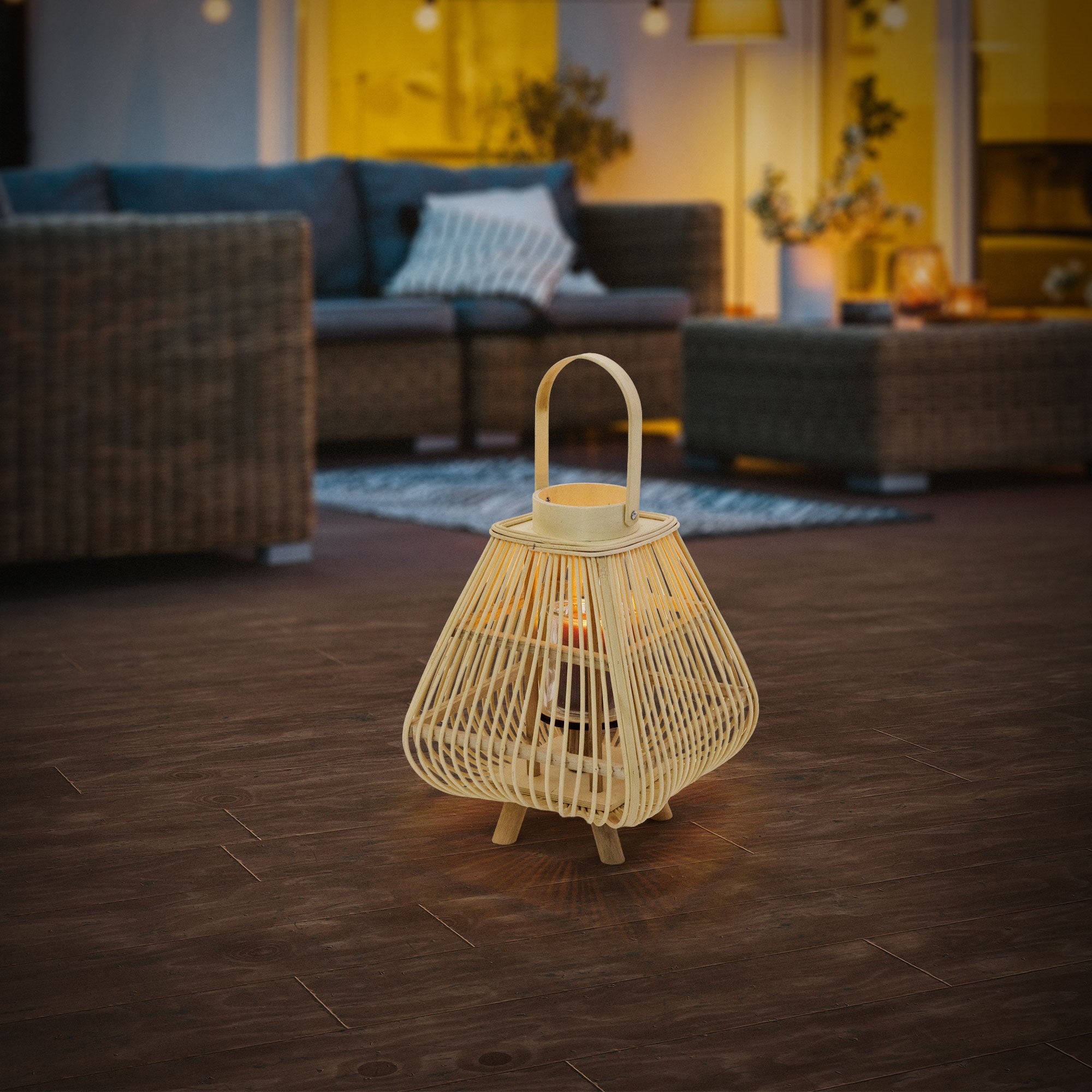 Bamboo lantern on a wooden floor, surrounded by furniture, in twilight.
