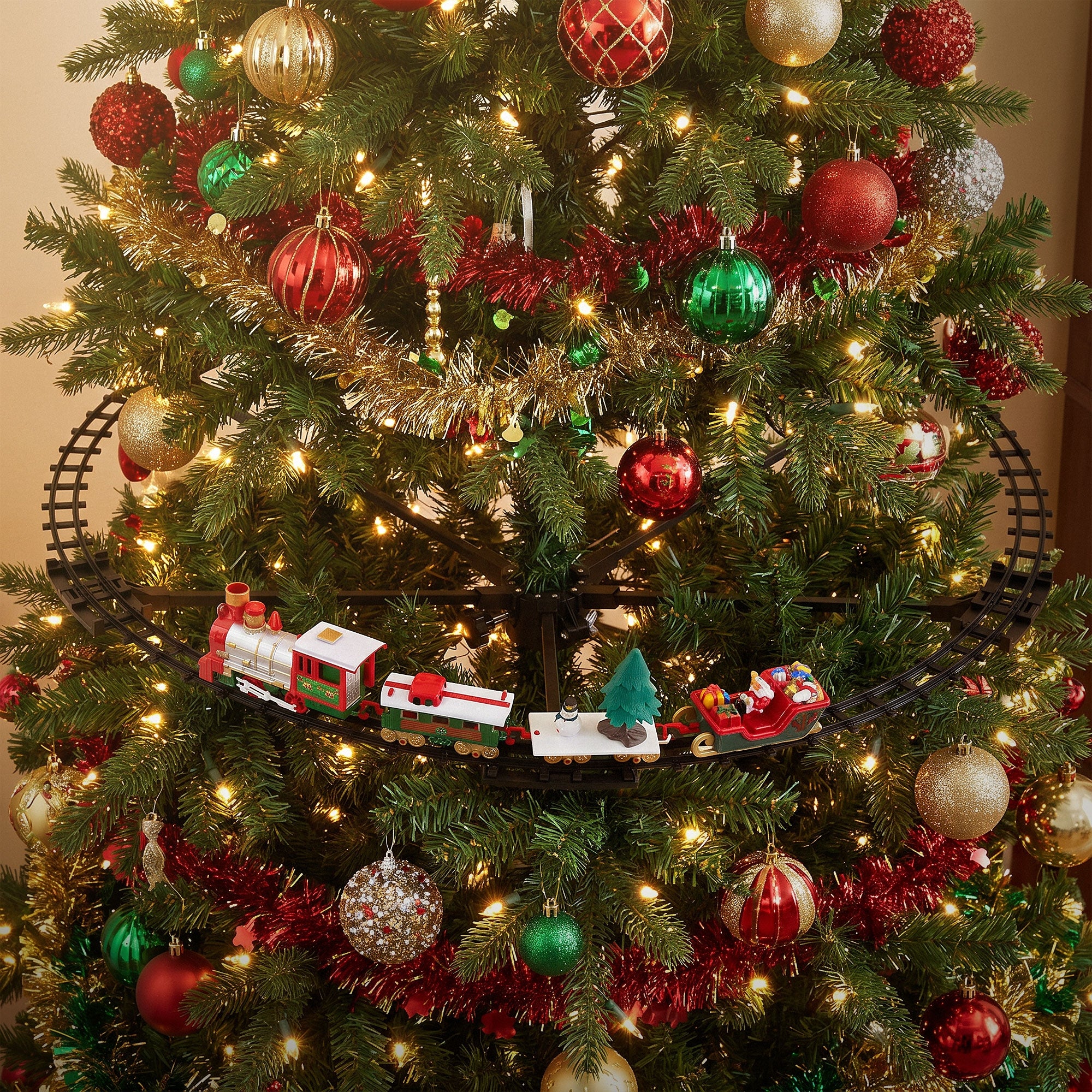 Train on a Christmas tree with colorful ornaments and lights.