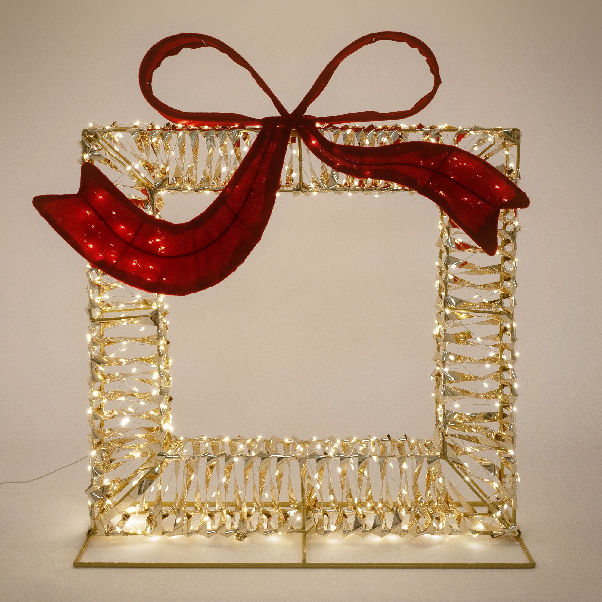LED-Rahmen mit rotem Schleifenmotiv, beleuchtet, goldfarbenes Design.