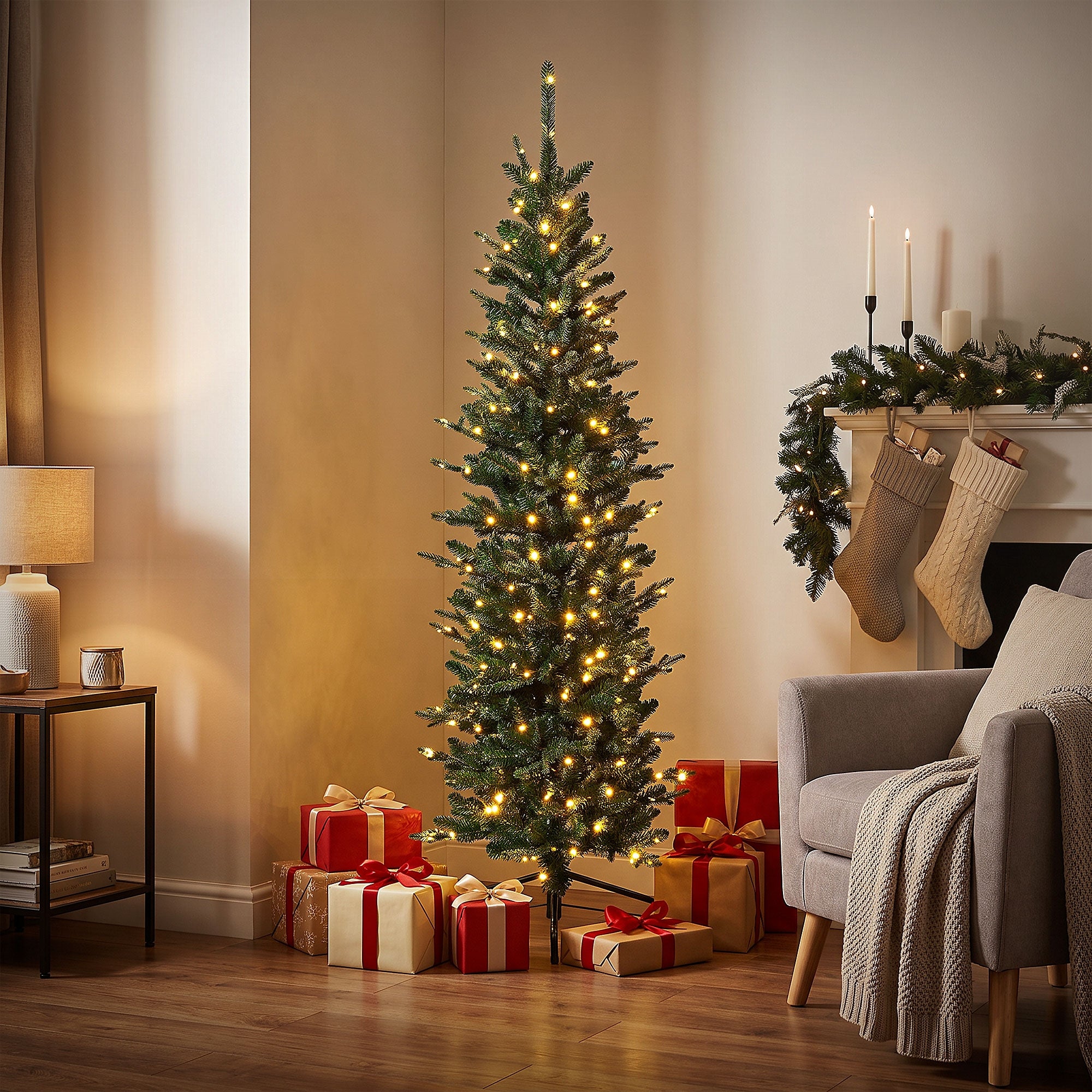 Christmas tree with lights and gifts in a living room.