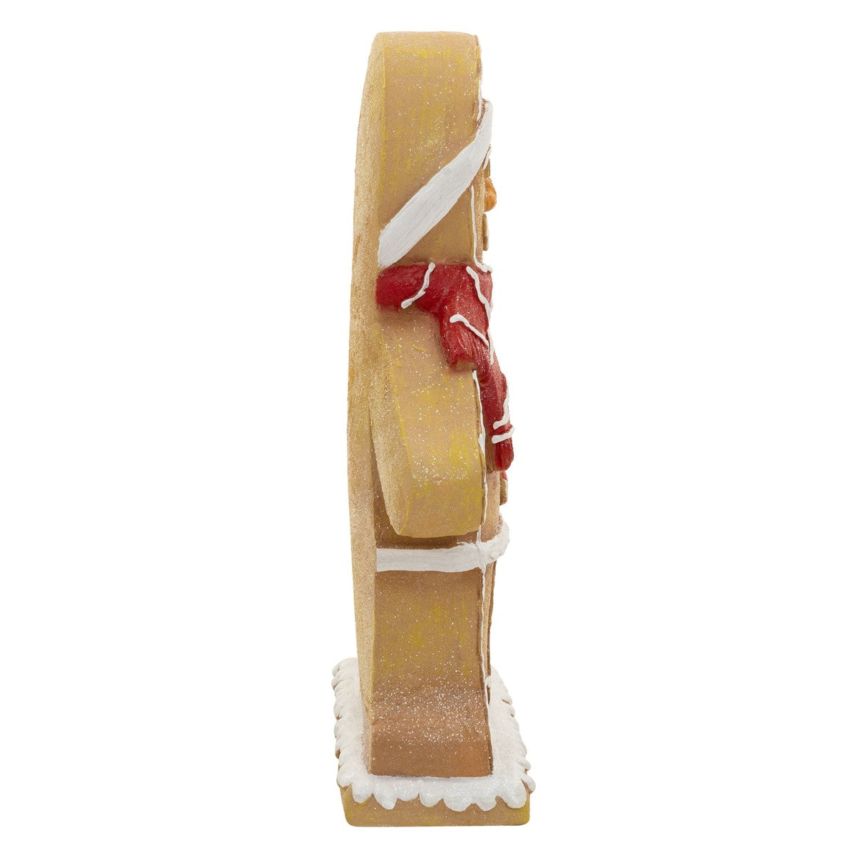 Eine Figur in Form eines Lebkuchenmanns von der Seite, mit rotem Schal.