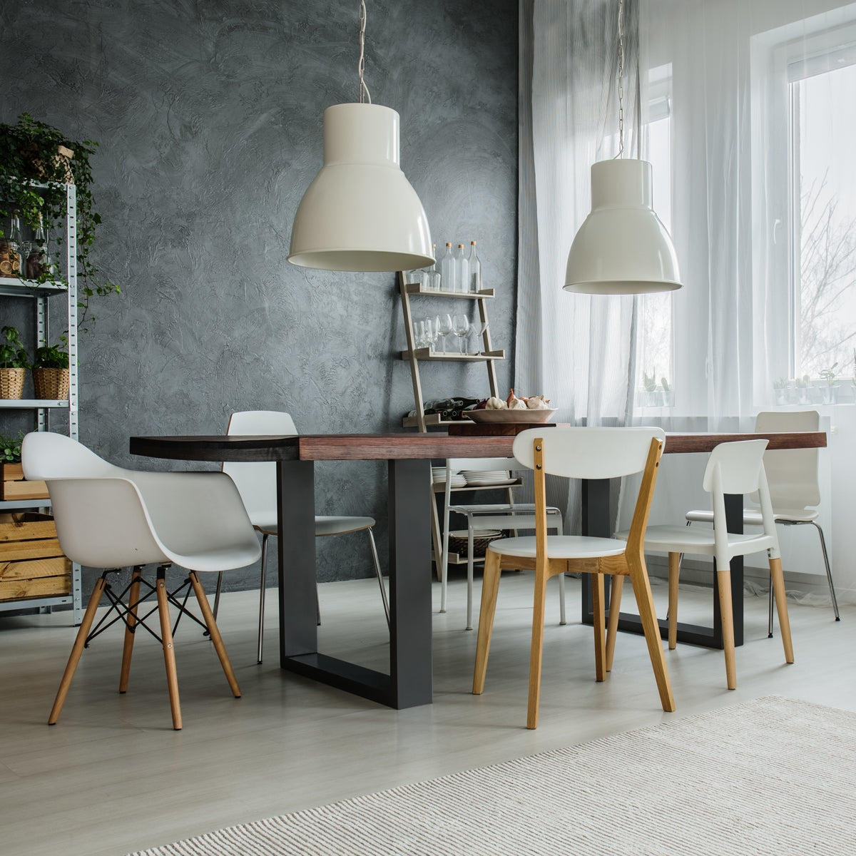 A dining area with a large table and several chairs in a bright room.