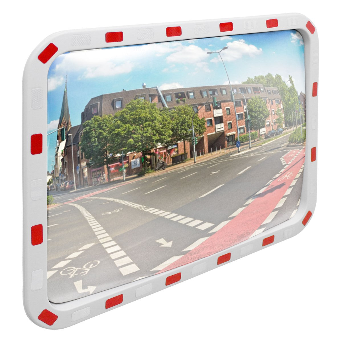 Traffic mirror with a red border, showing a road with trees and buildings.